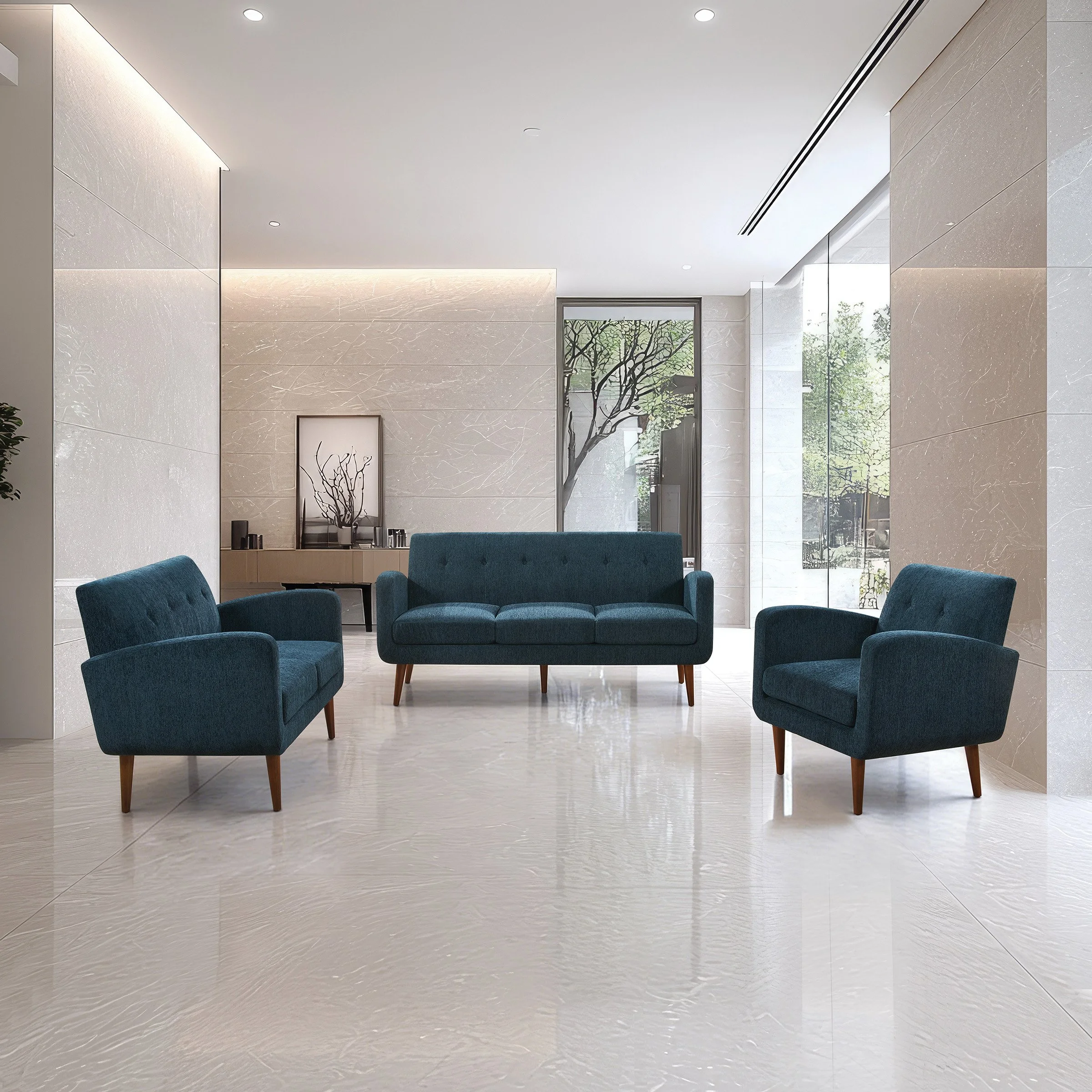 Modern lobby with three blue upholstered seating pieces, a sofa and two armchairs, in a minimalist decor with beige marble walls and large windows with greenery outside.