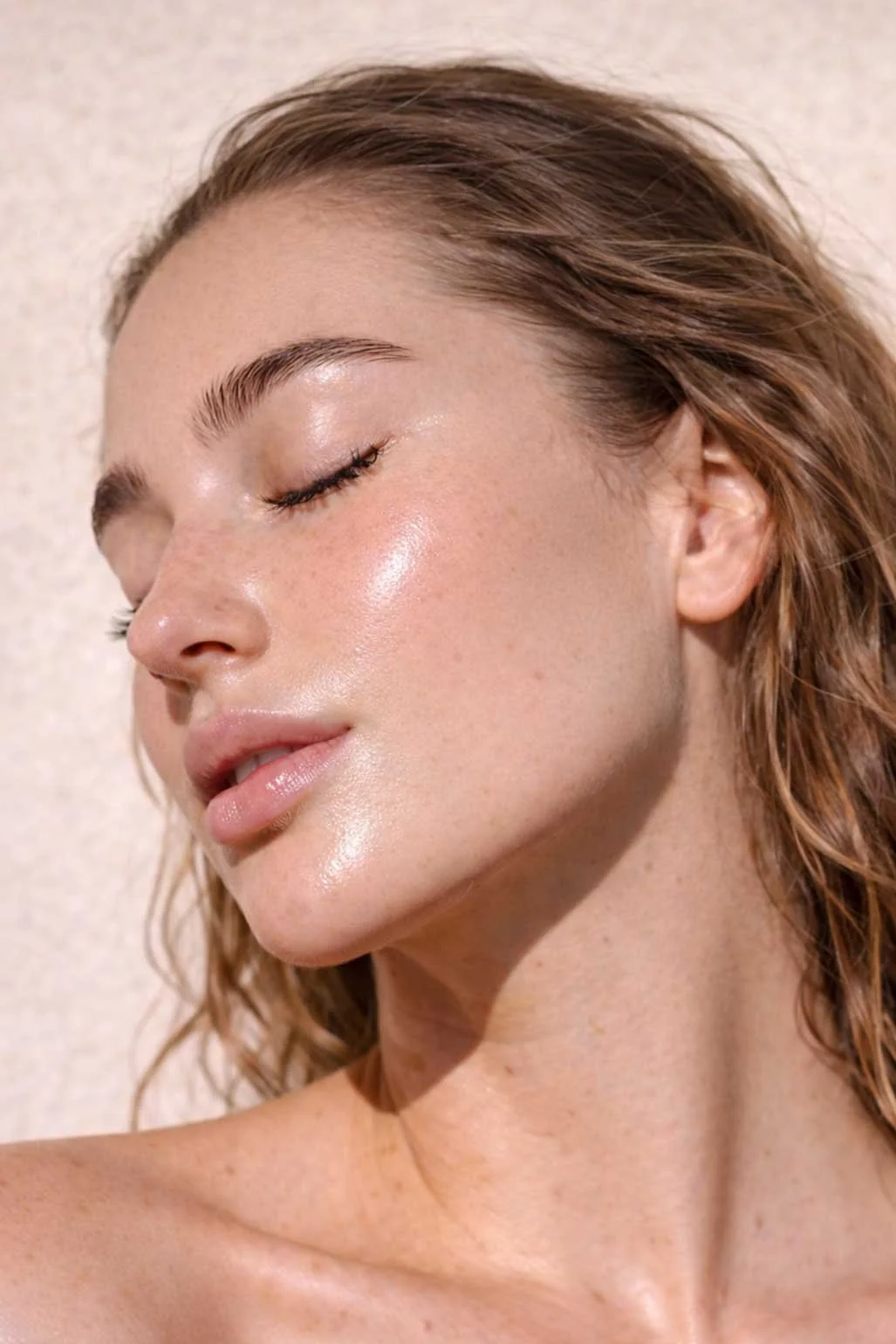Close-up profile of a woman with luminous glowing skin after a professional brightening facial treatment at Lunar Ambitions in Orlando FL.