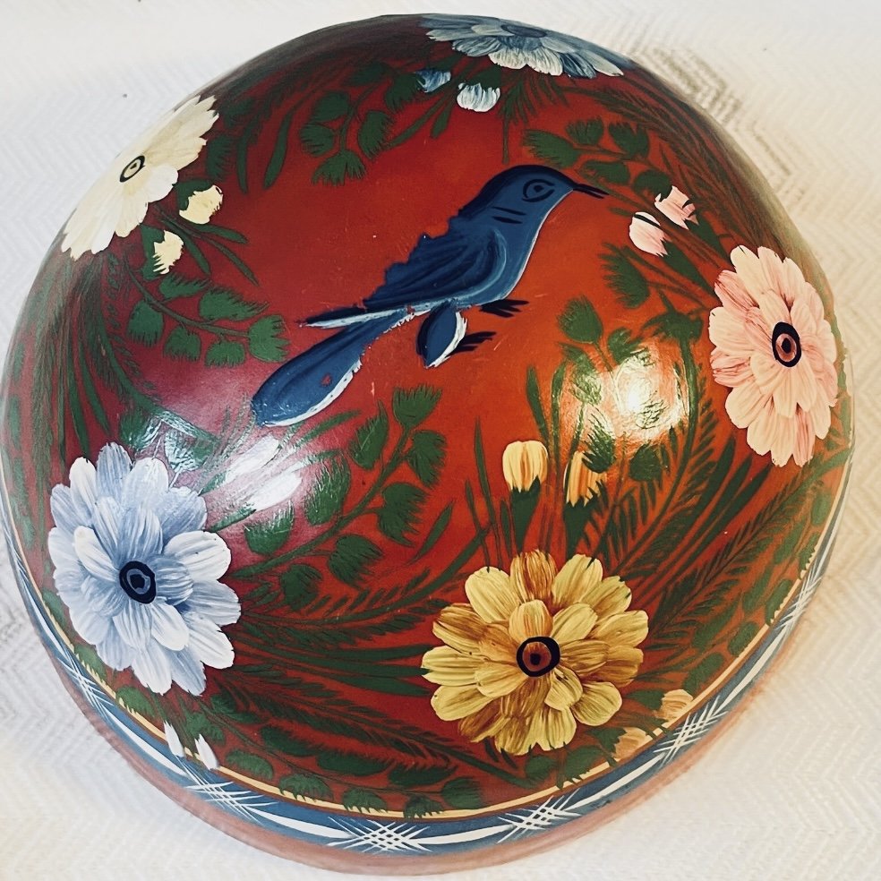 Round wood bowl painted red with bird and flowers