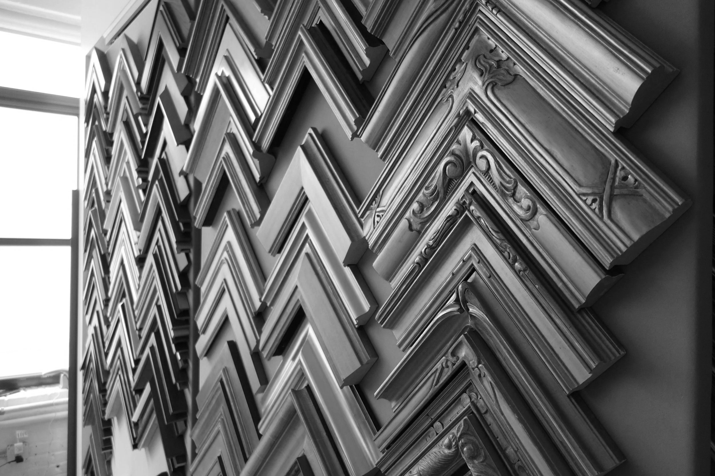 Finished-corner frame samples for fine art framing, Paris Frames NYC showroom wall display