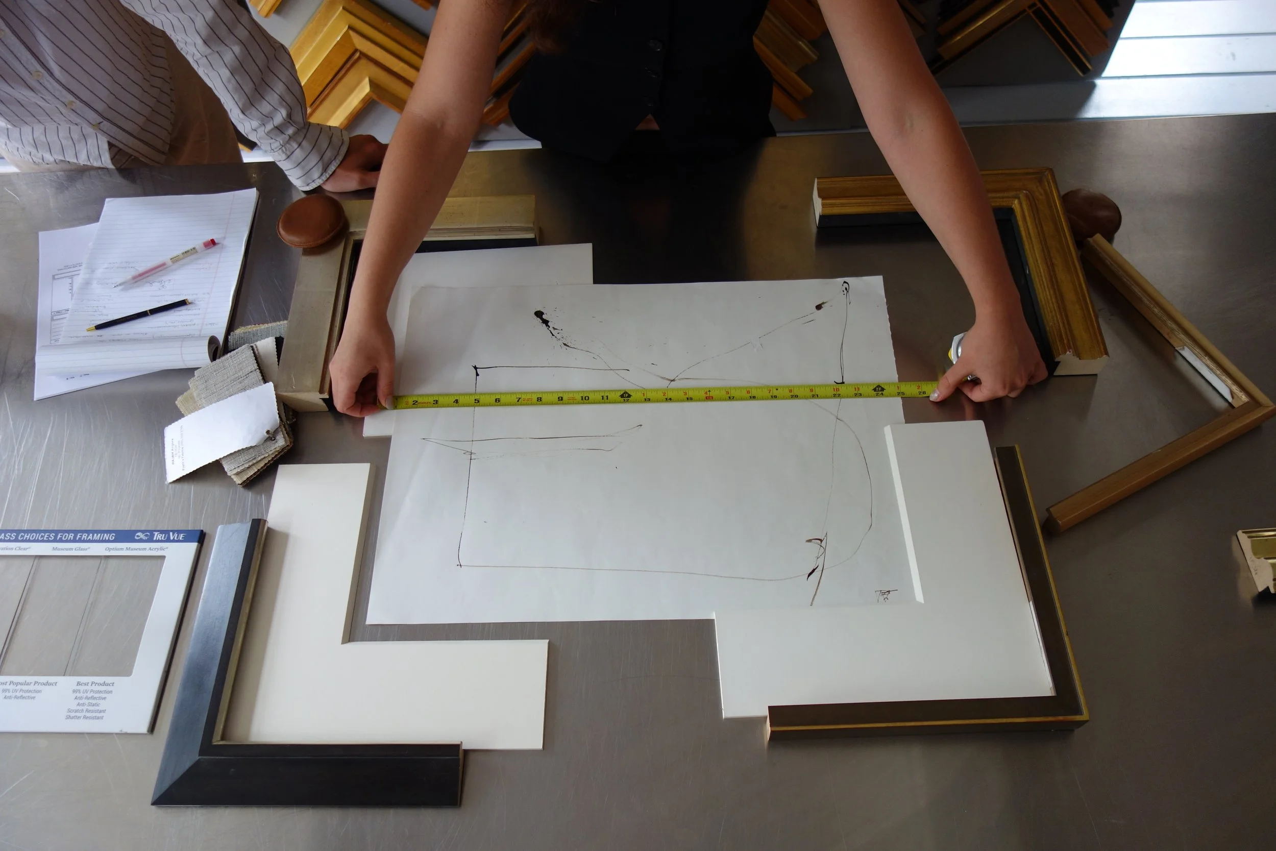Measuring artwork for custom framing appointment at Paris Frames NYC, Long Island City / Queens showroom