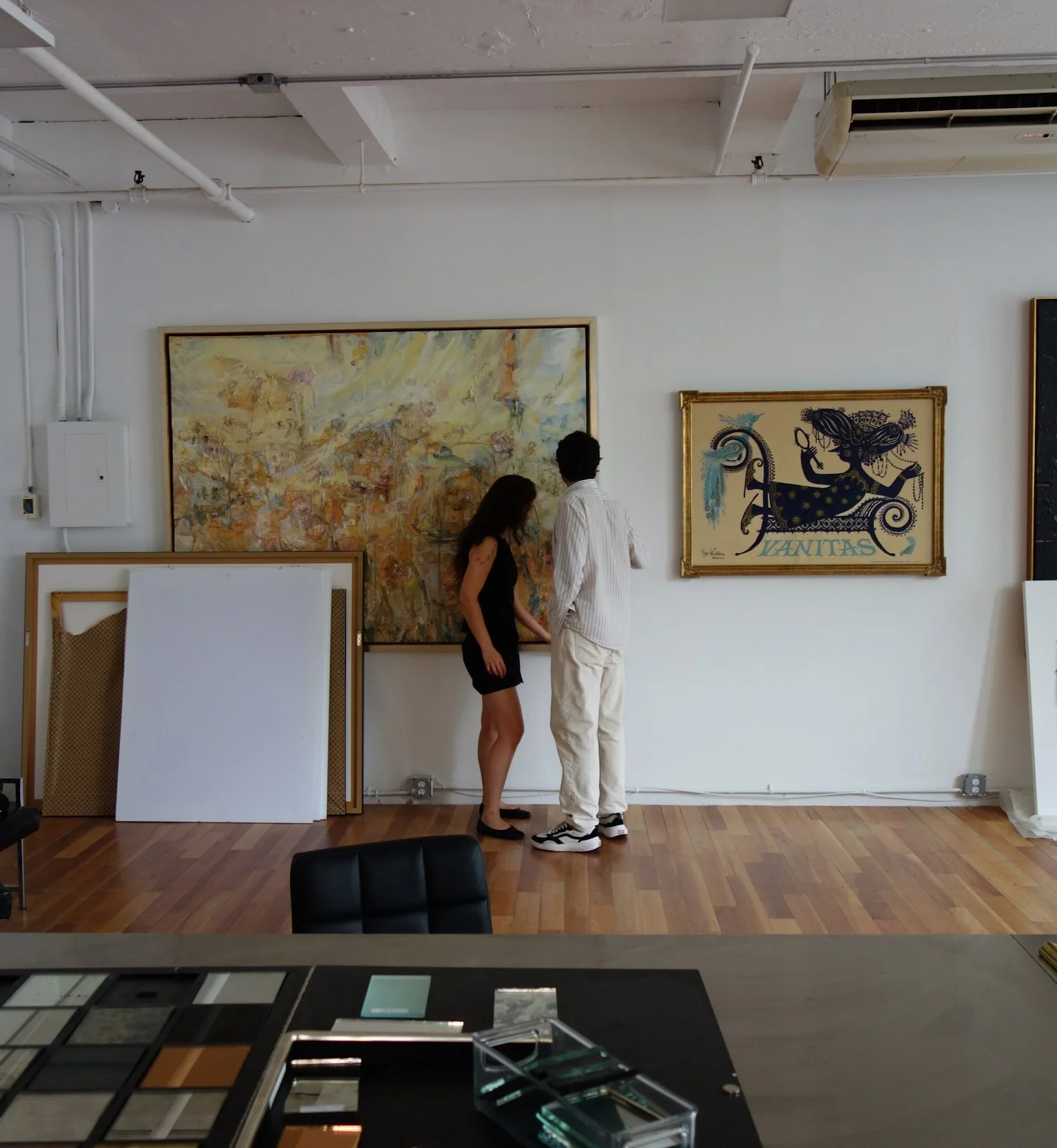 Client consultation at Paris Frames NYC gallery — finished-corner frame and fine art canvas display