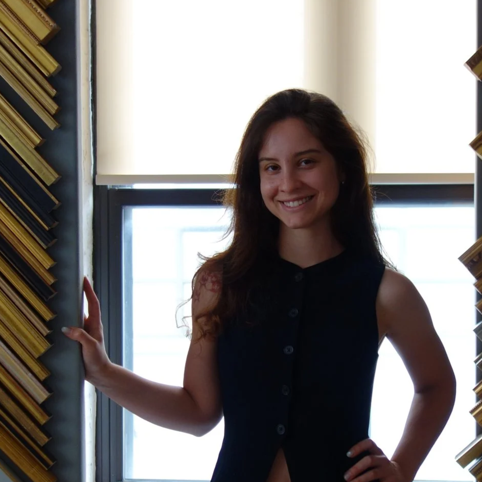 Lily Bridges, Head Framing Consultant at Paris Frames NYC, beside finished-corner frame samples
