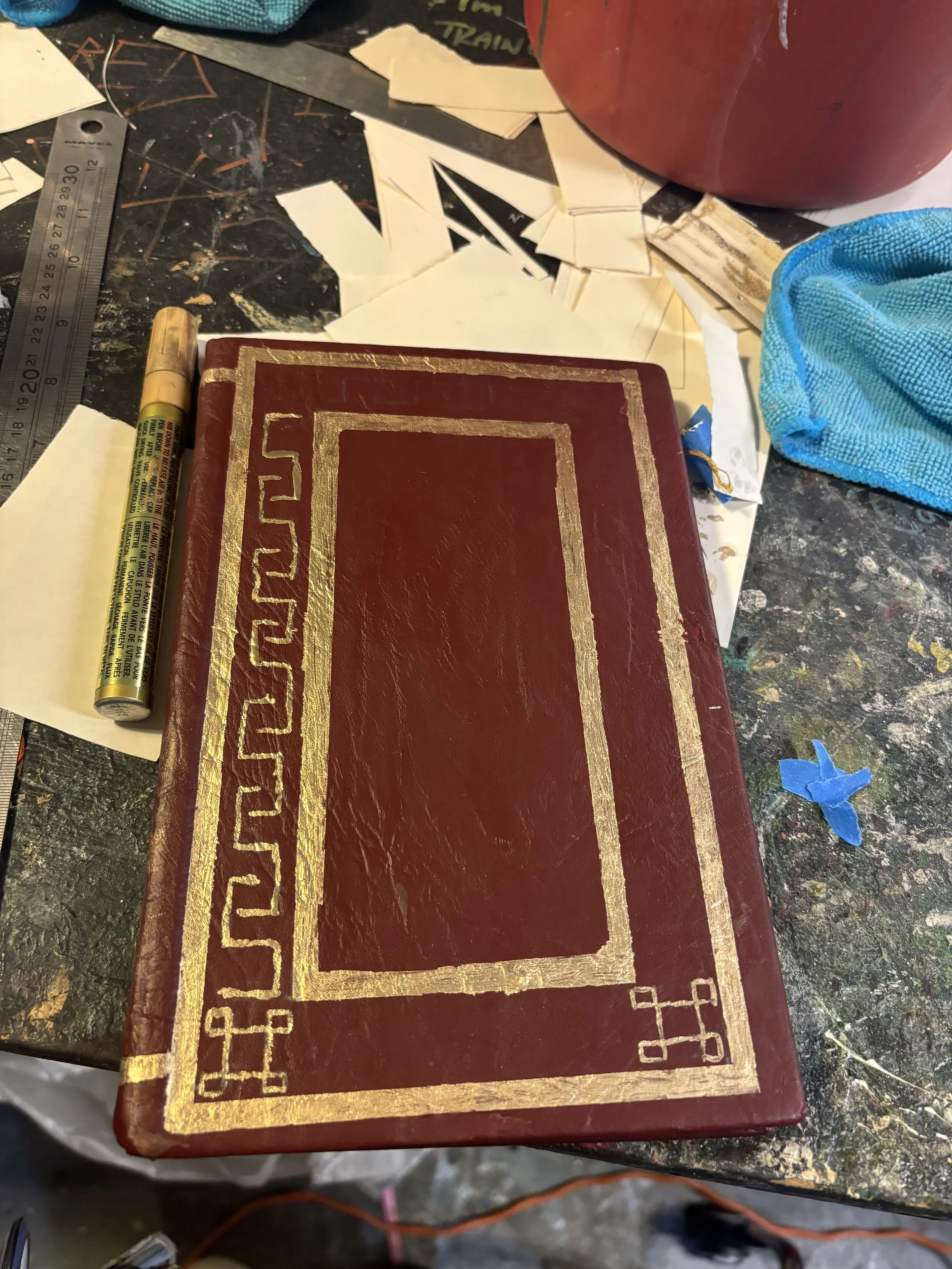 Page’s Journal (in progress-front), made with leather notebook, acrylic paint, and paint pen