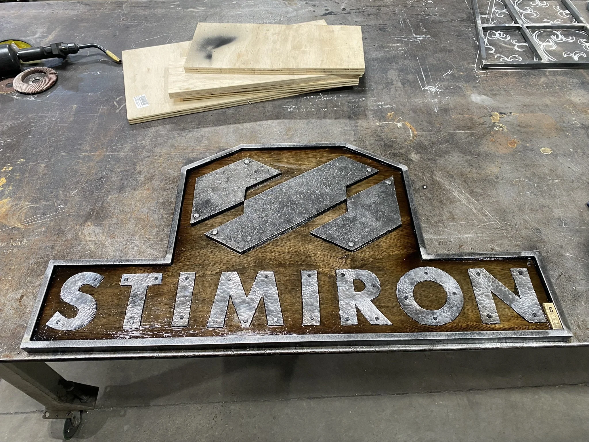 StimIron Sign - Forged in steel with hardwood backing.  This sign hangs in Hidemasa Yamagishi's gym, Powerhouse Gym.  As a world-class Bodybuilder, it was a pleasure to work with Hide on a personal sign for his clothing brand. LV
