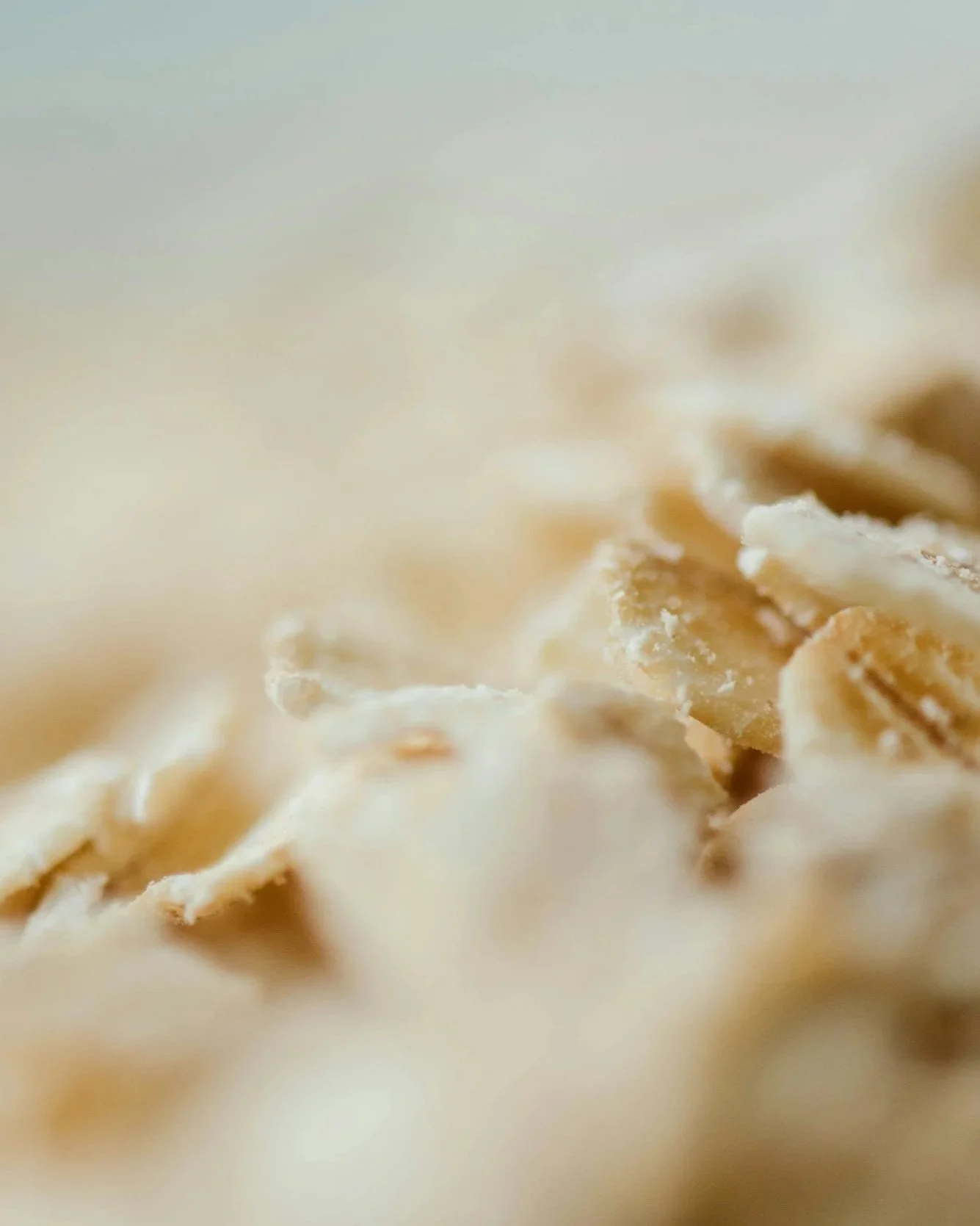 Close-up of shredded cheese with a creamy, melted texture.