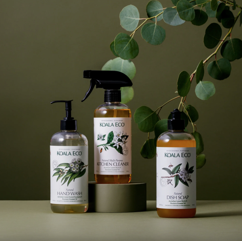 Three Koala Eco eco-friendly cleaning products: hand wash, kitchen cleaner, and dish soap, with eucalyptus leaves in the background.