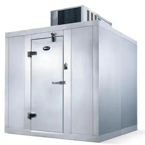 Large commercial refrigeration unit with a metal door and an air conditioning unit on top.