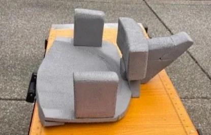 A foam sculpture resembling a cartoon bunny with large ears, placed on a wooden surface.