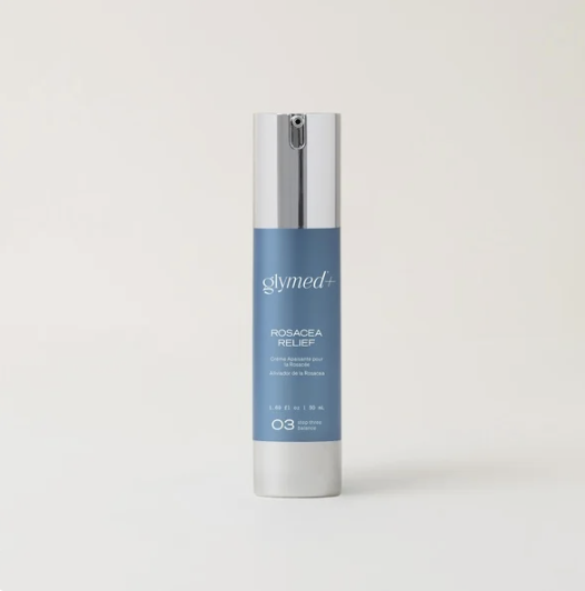 A cylindrical skincare product bottle with a white and silver cap, blue body, and white text that reads 'glymed+ ROSACEA RELIEF'.