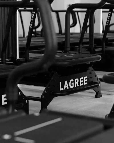 Row of black Lagree reformers.