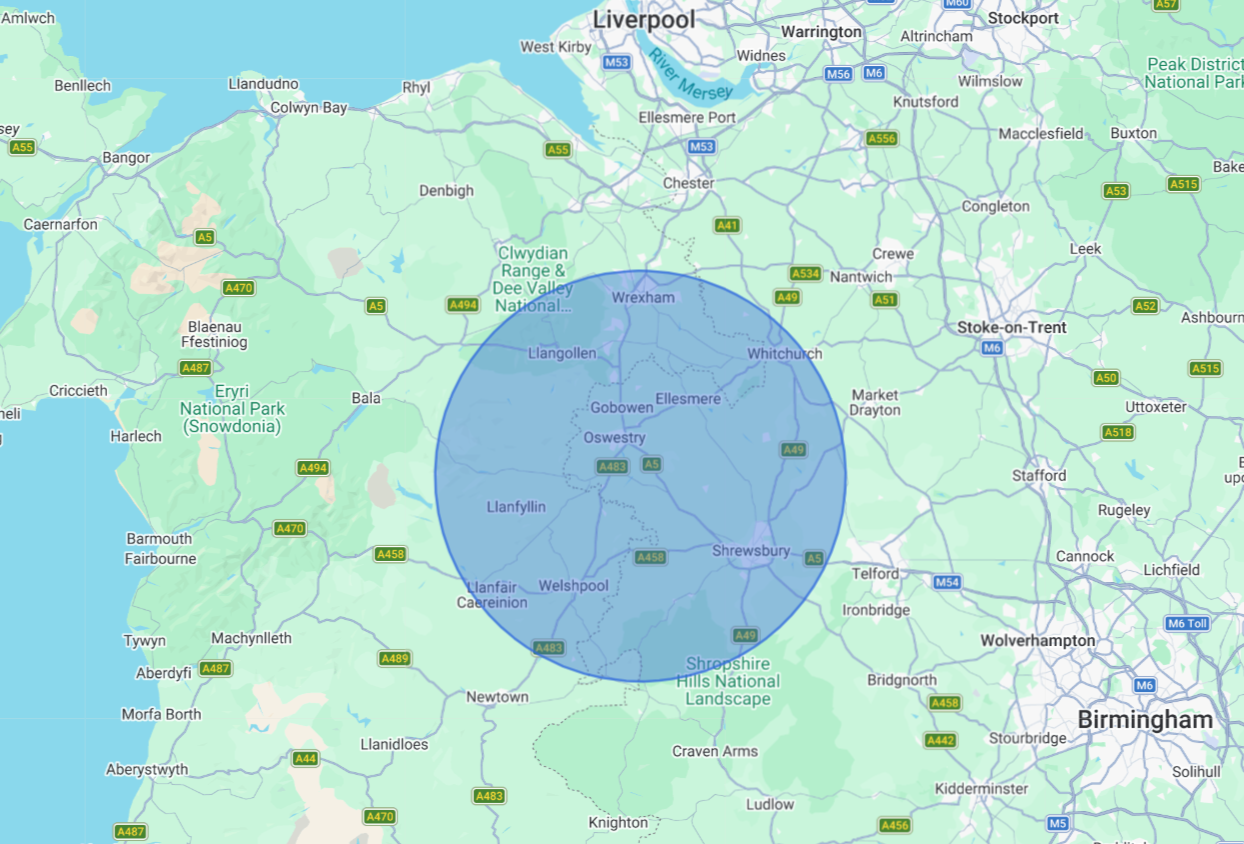 Map of part of North Wales showing towns, roads, and a shaded circle overlay.