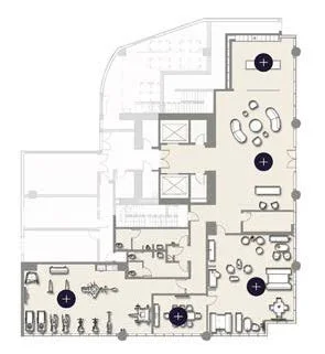 Floor plan of an office space with designated areas for meeting rooms, workstations, and communal areas.