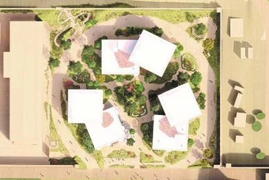 Aerial view of a residential complex with multiple white buildings, surrounded by green landscaping and pathways.