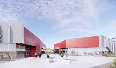 Modern building with red and white exterior, people walking outside on a clear day.