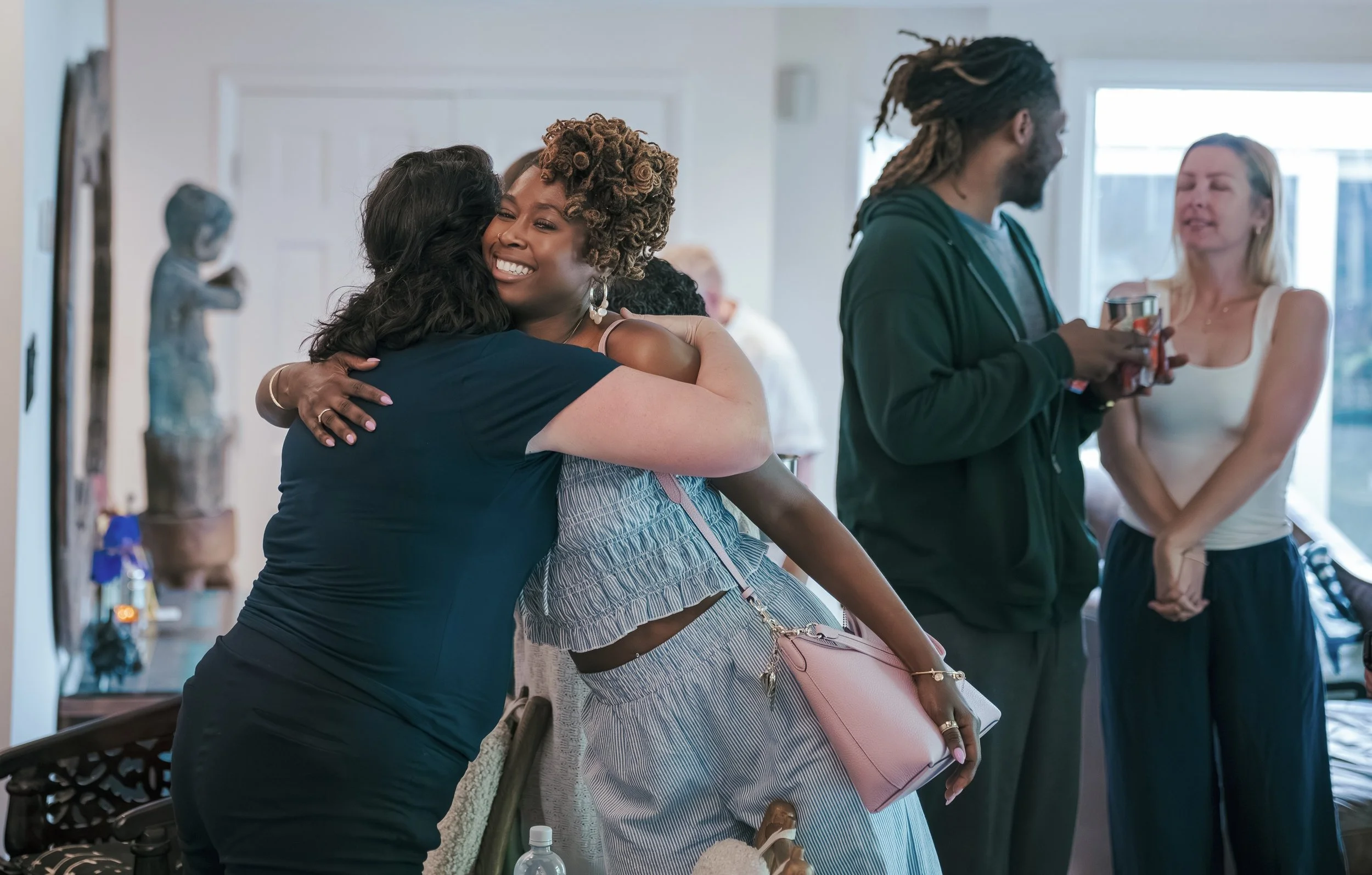 Sakhi Yoga School students hug in a fitting image. The name for our school was chosen as a reminder of the ancient teachings that emphasize the importance of walking our paths together, in friendship and support of one another. 