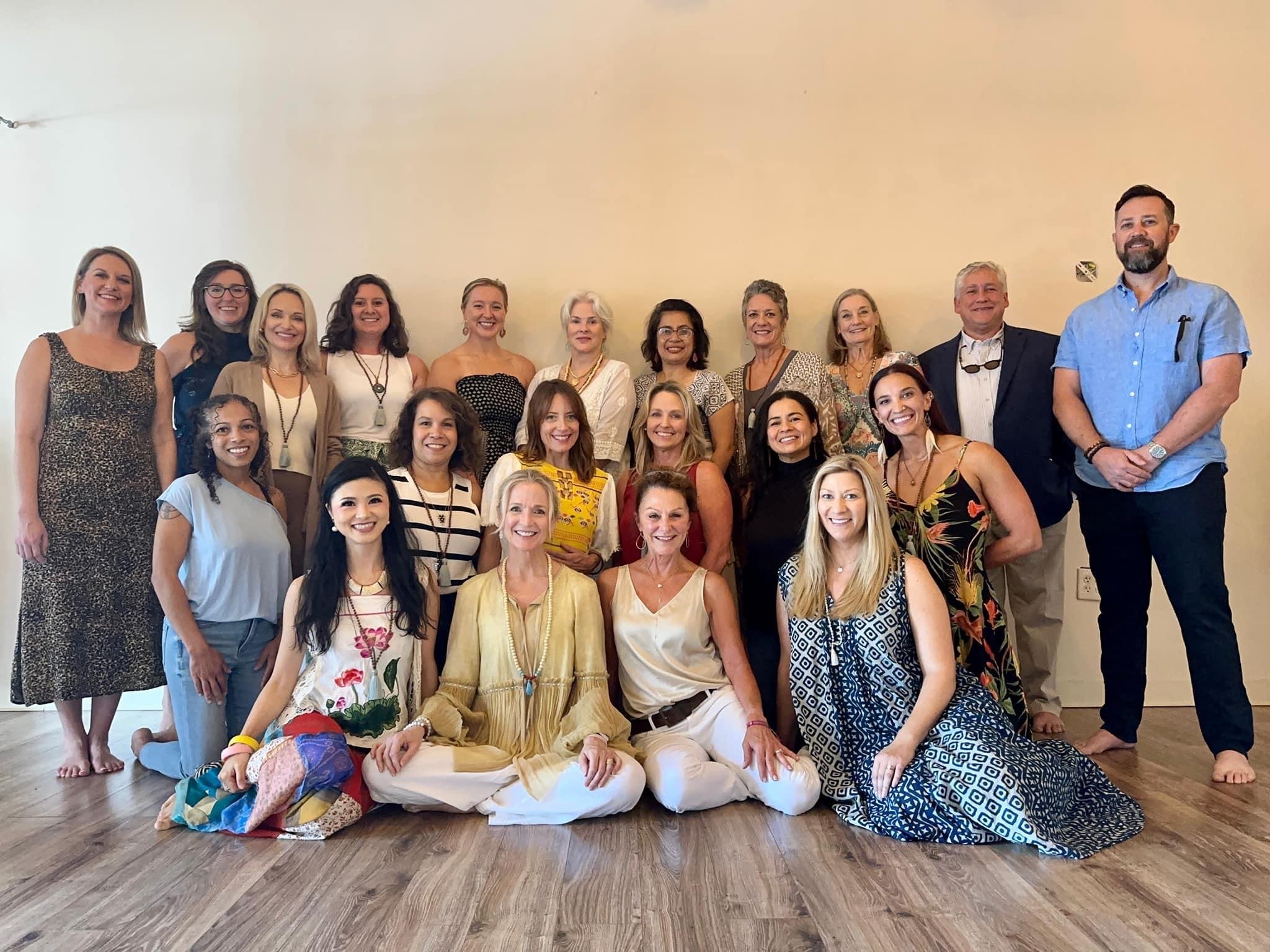 A diverse group of teacher trainees from Sakhi Yoga School gather for a portrait at the end of their training program.