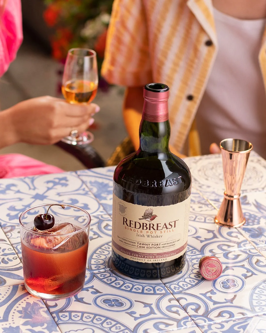 Redbreast Tawny Port Irish whiskey and cocktail lifestyle photography with warm lighting in summer setting.