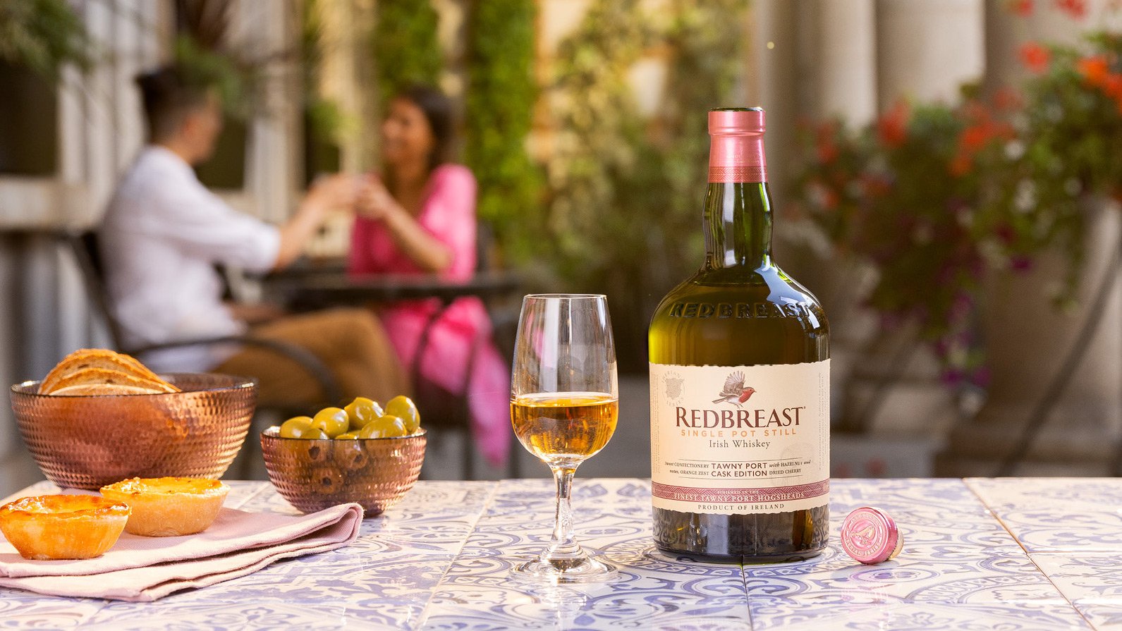 Redbreast Tawny Port Irish whiskey and cocktail lifestyle photography with warm lighting in summer setting.
