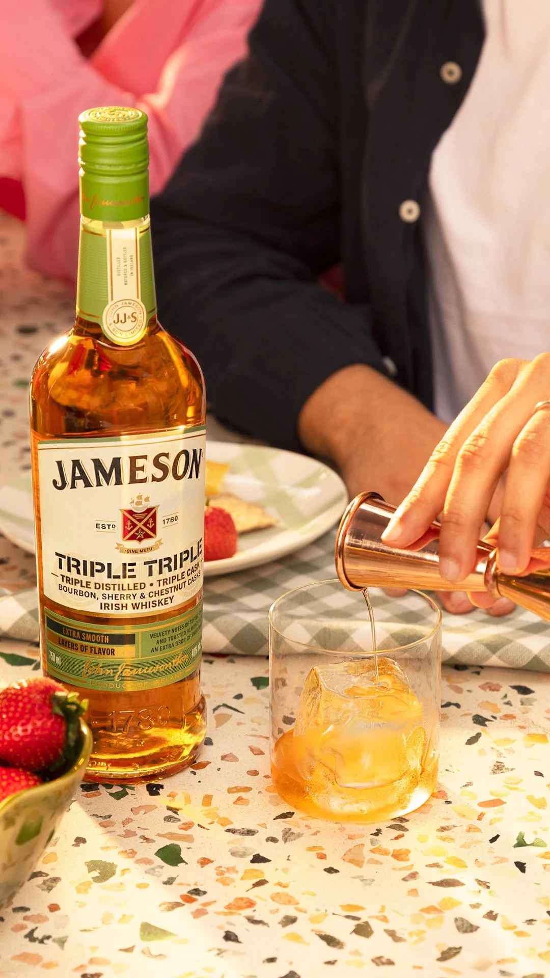 Jameson irish whiskey Triple Triple pour over ice in lifestyle setting