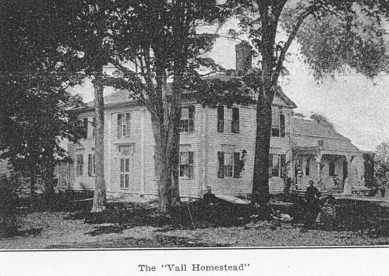 A historic photograph of a large, two-story house labeled 'The Vail Homestead' with a man on a horse and trees in the foreground.