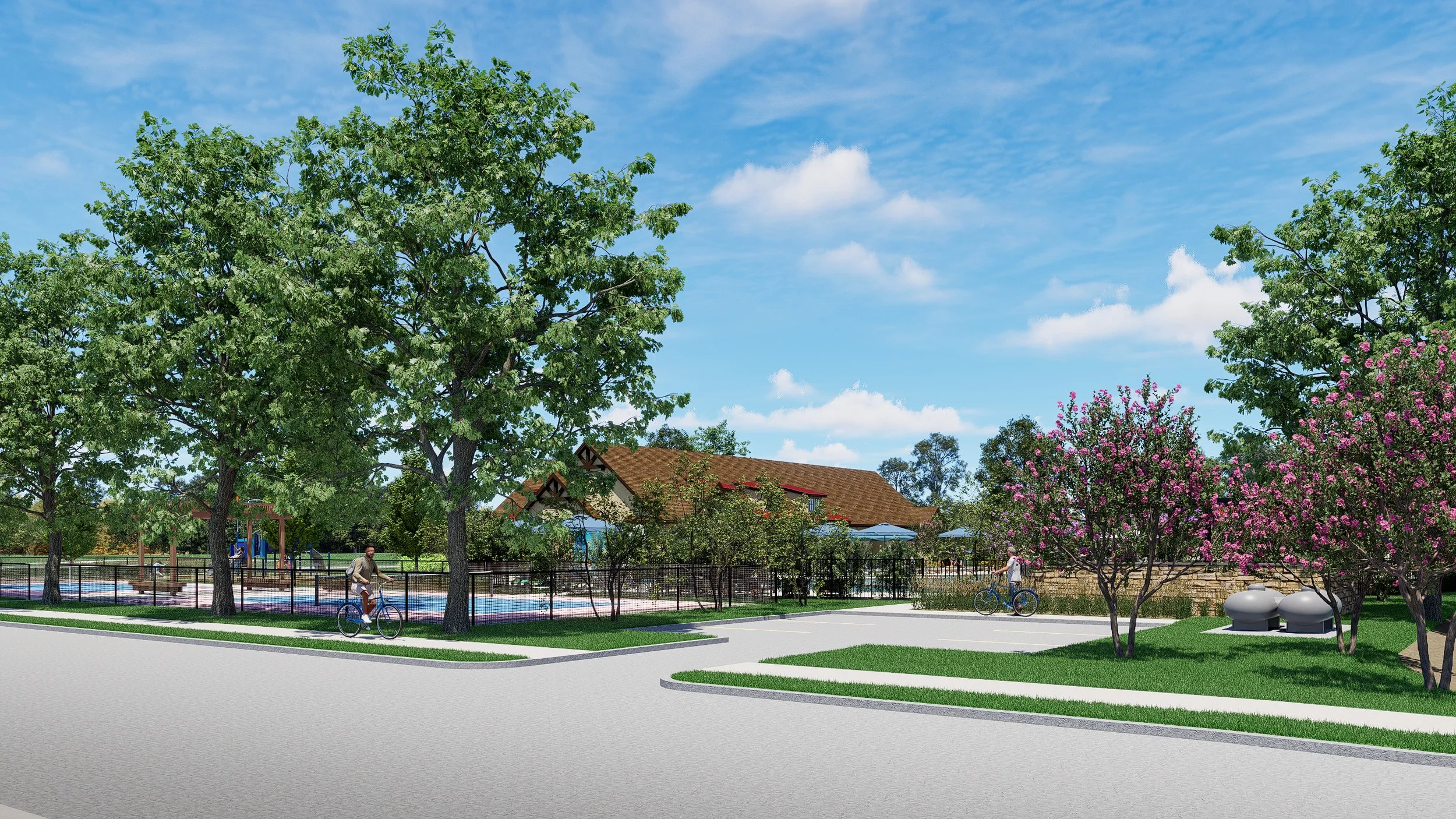 A park scene with trees, pink flowering bushes, a paved pathway, a fenced playground, two people riding bicycles, and clear blue skies with a few clouds.
