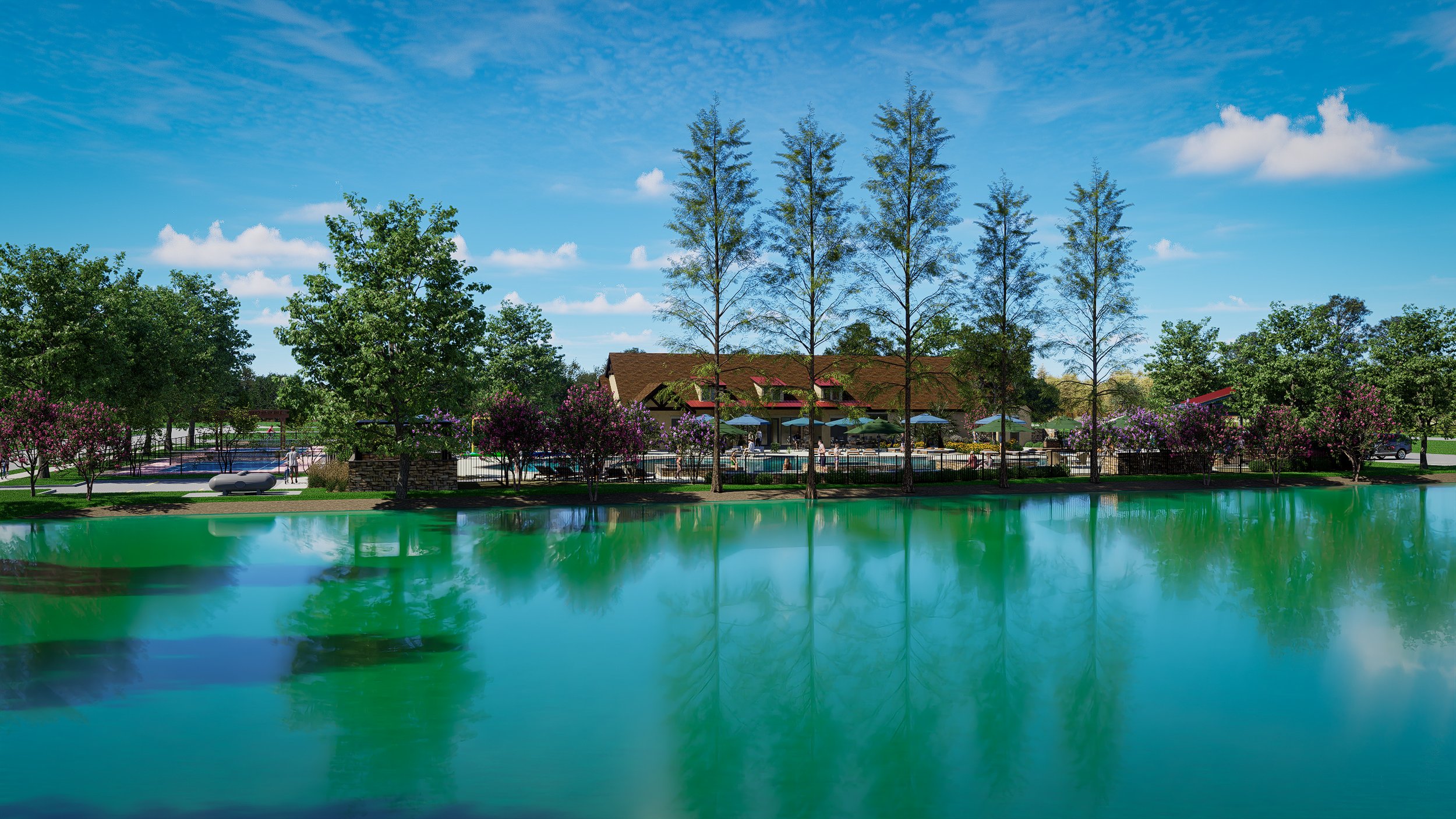 A peaceful lakeside scene with a building, trees, and a pool area in the background under a blue sky with clouds.