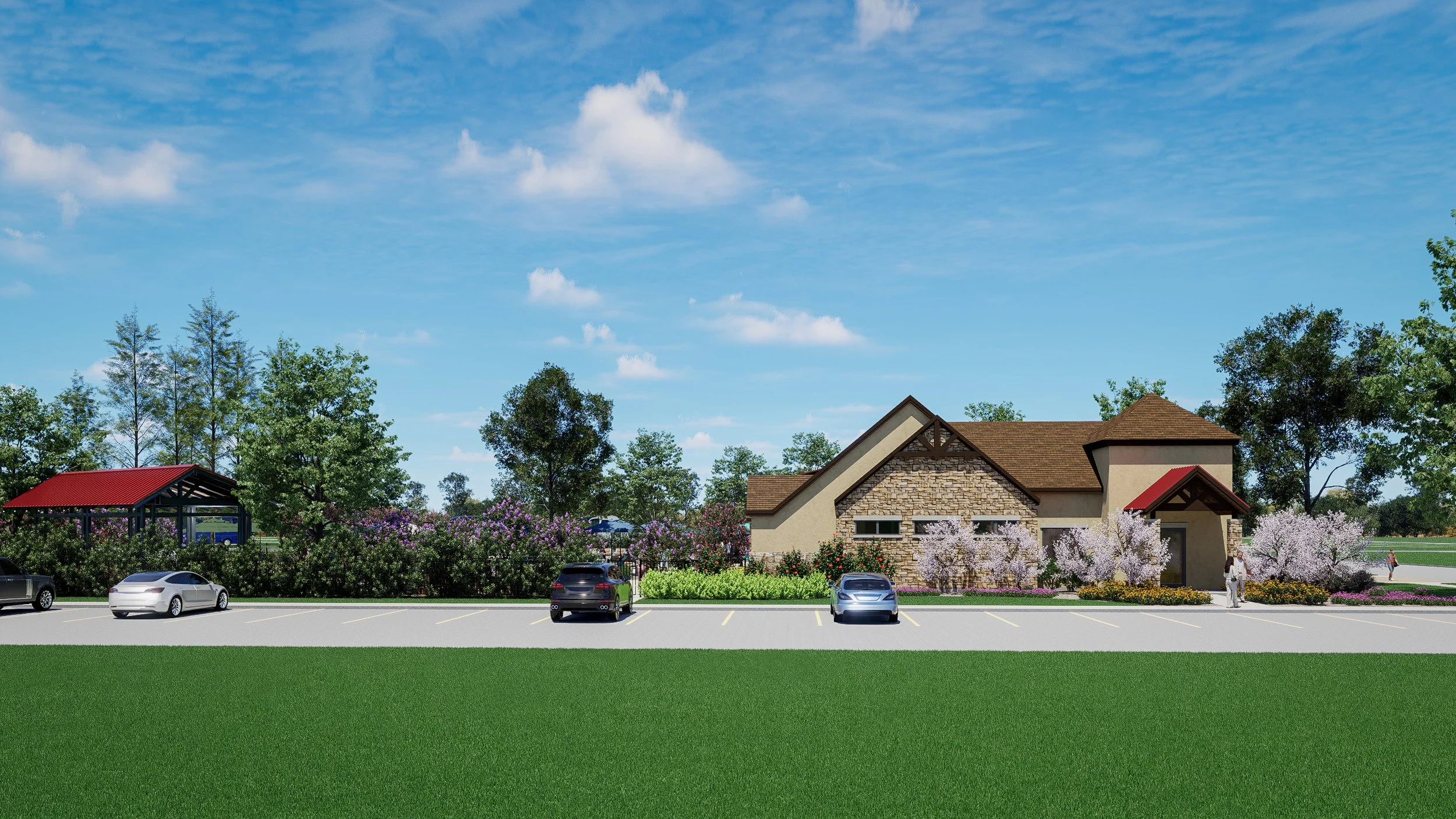 A house with a brick and stucco exterior, surrounded by flowering bushes and trees, under a partly cloudy blue sky, with a parking lot and cars in front.
