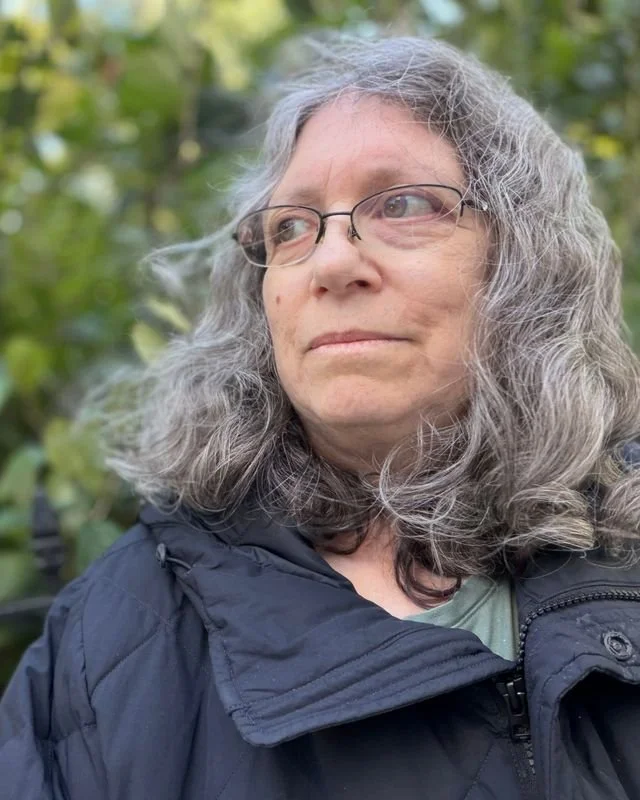 Karen Bromberg outdoors, looking off to the side