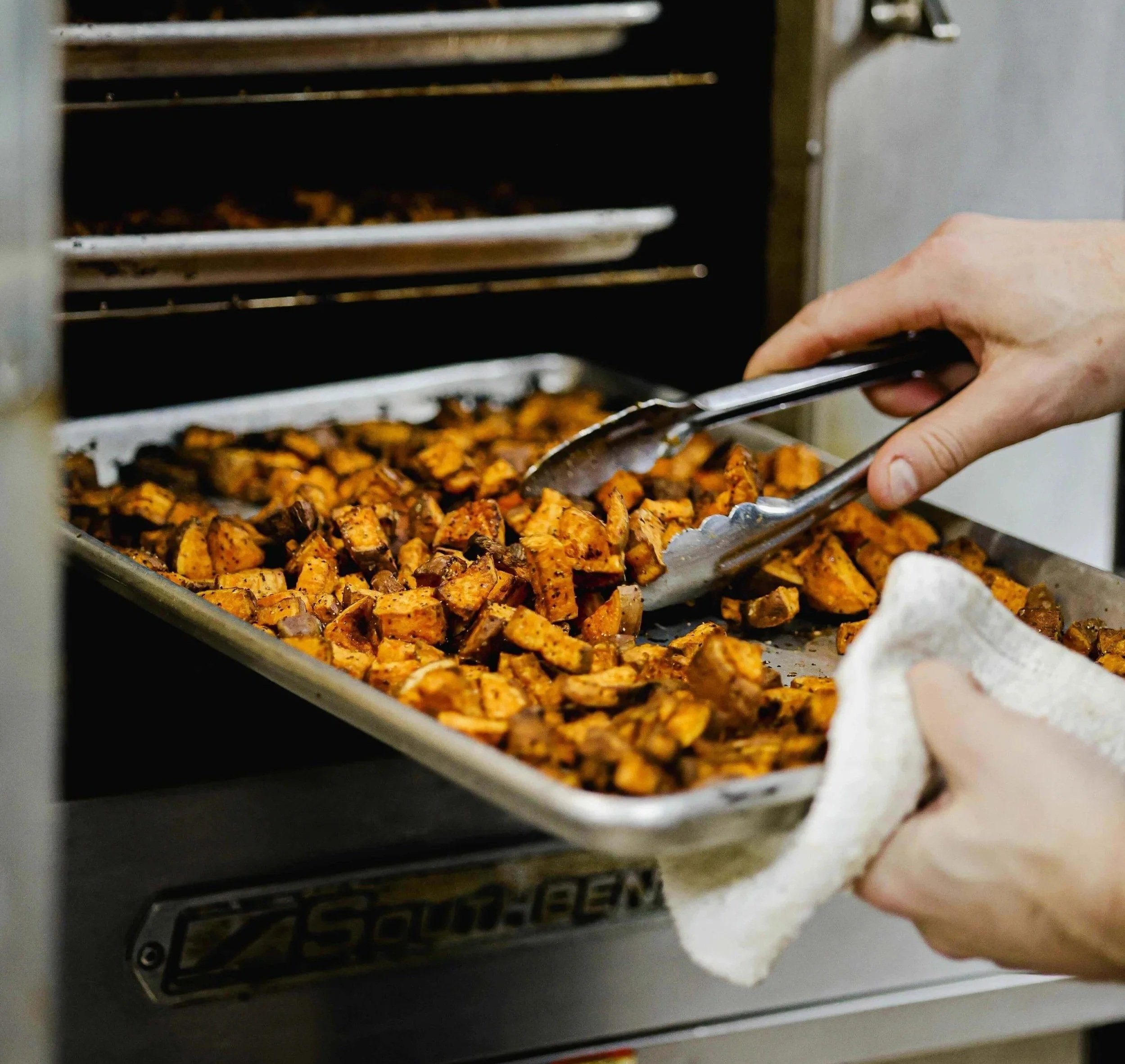 Roasted sweet potatoes coming out of the oven at DICED's prep kitchen