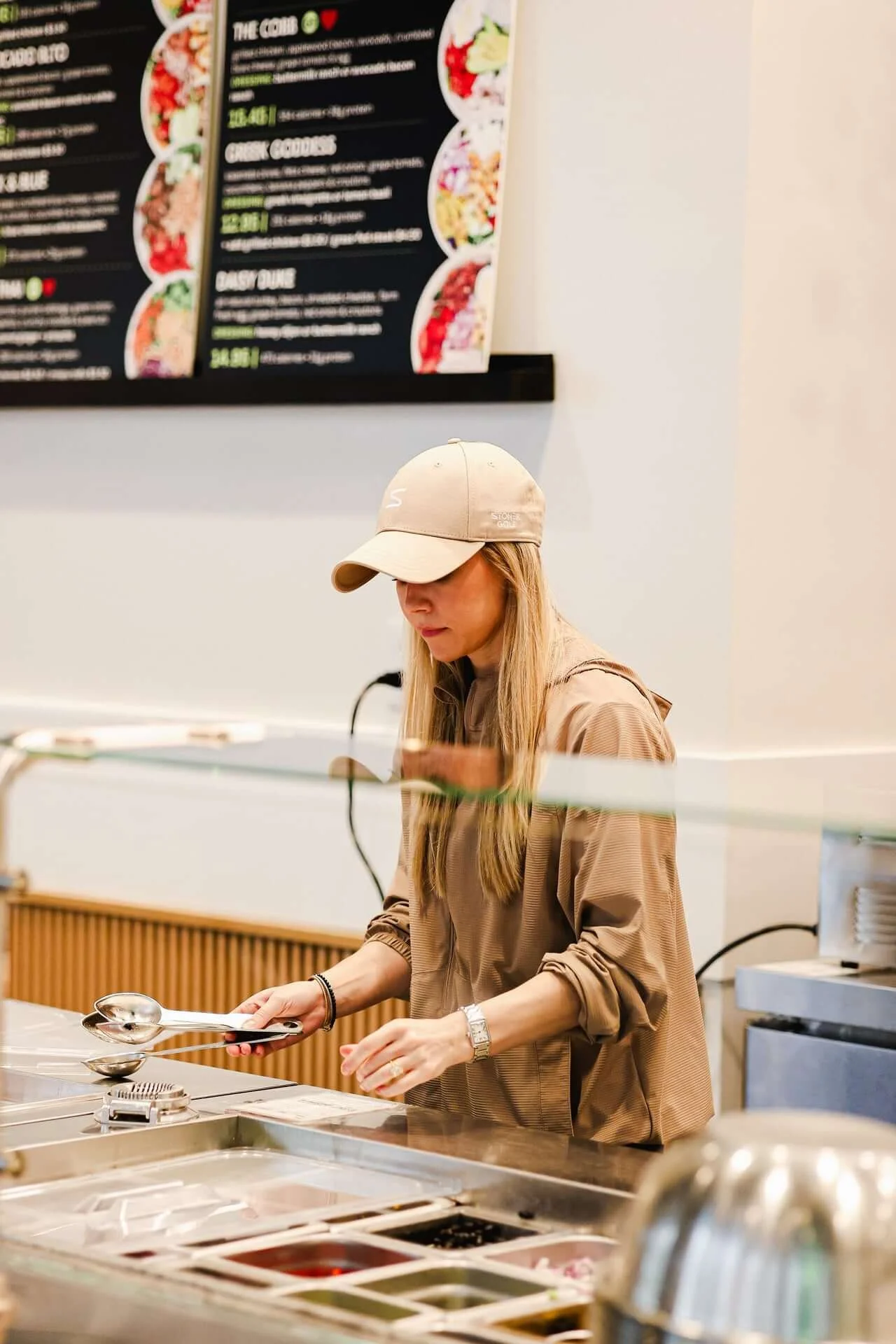 Michelle Woodward, founder of DICED, making a salad at the line