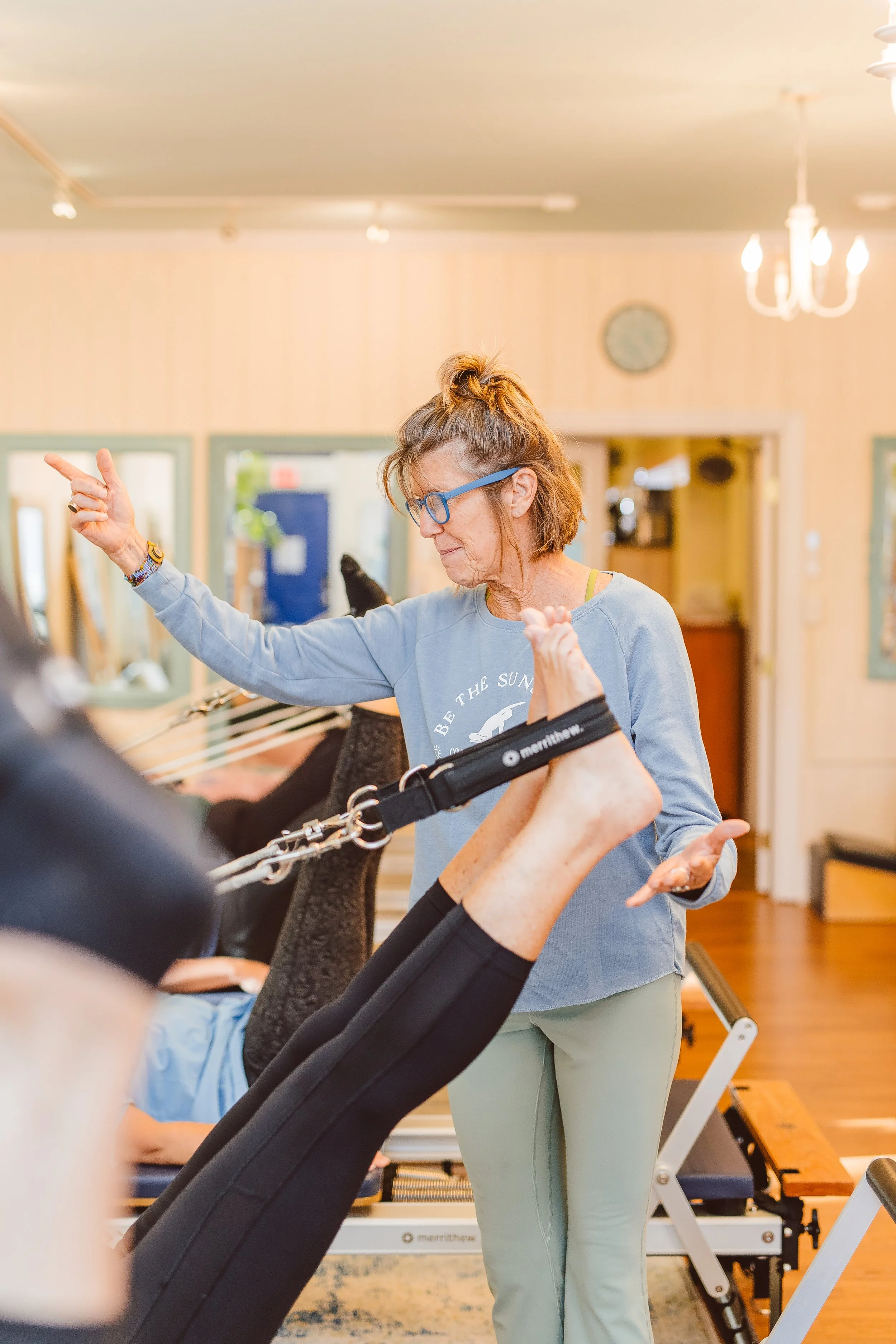 Coastal Retreat Studios certified Pilates instructor coaching a client in Easton, MD — personalized movement guidance in a small-group setting