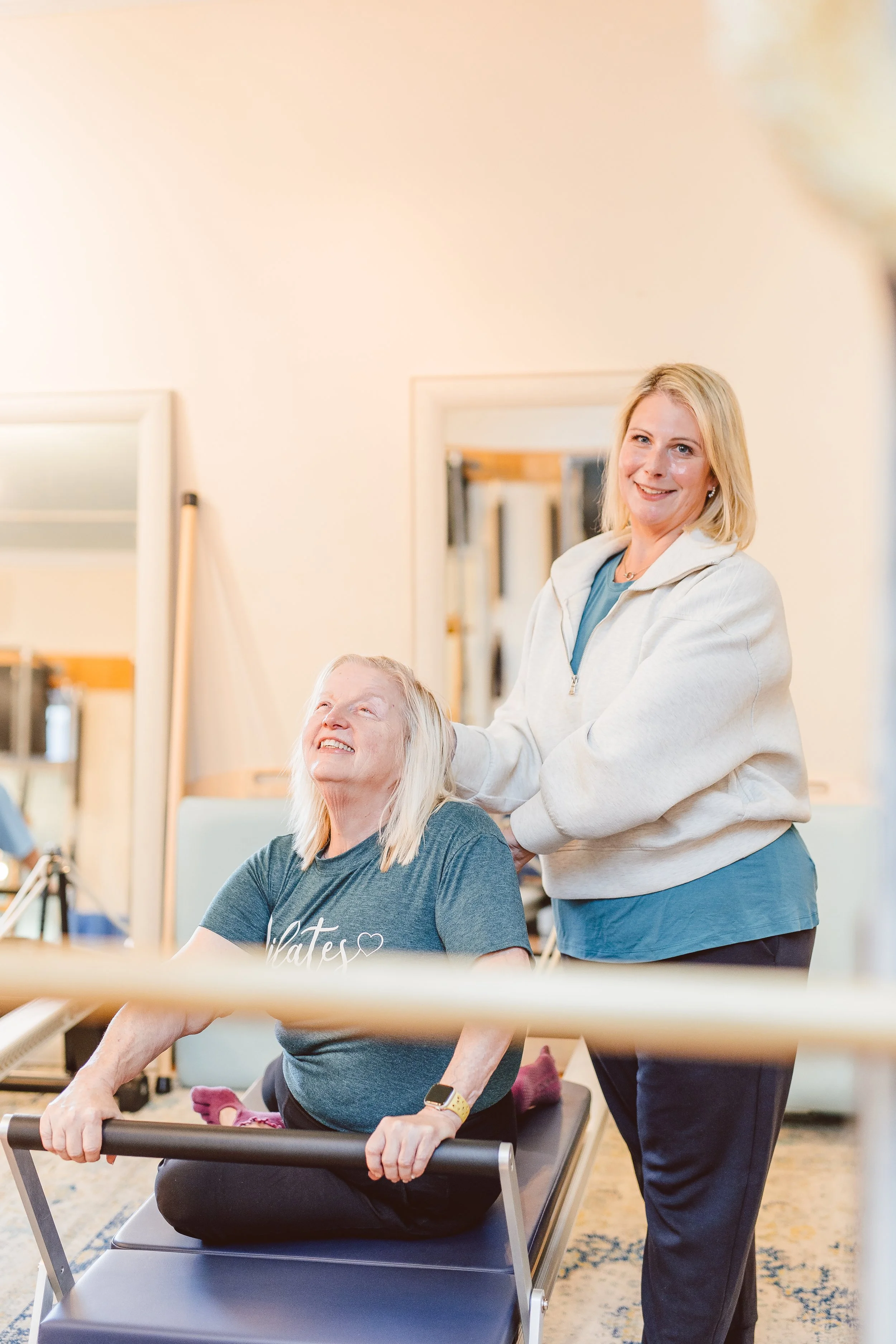 Coastal Retreat Studios Pilates instructor supporting a client — accessible, age-inclusive movement classes in Easton, MD for every body and every age