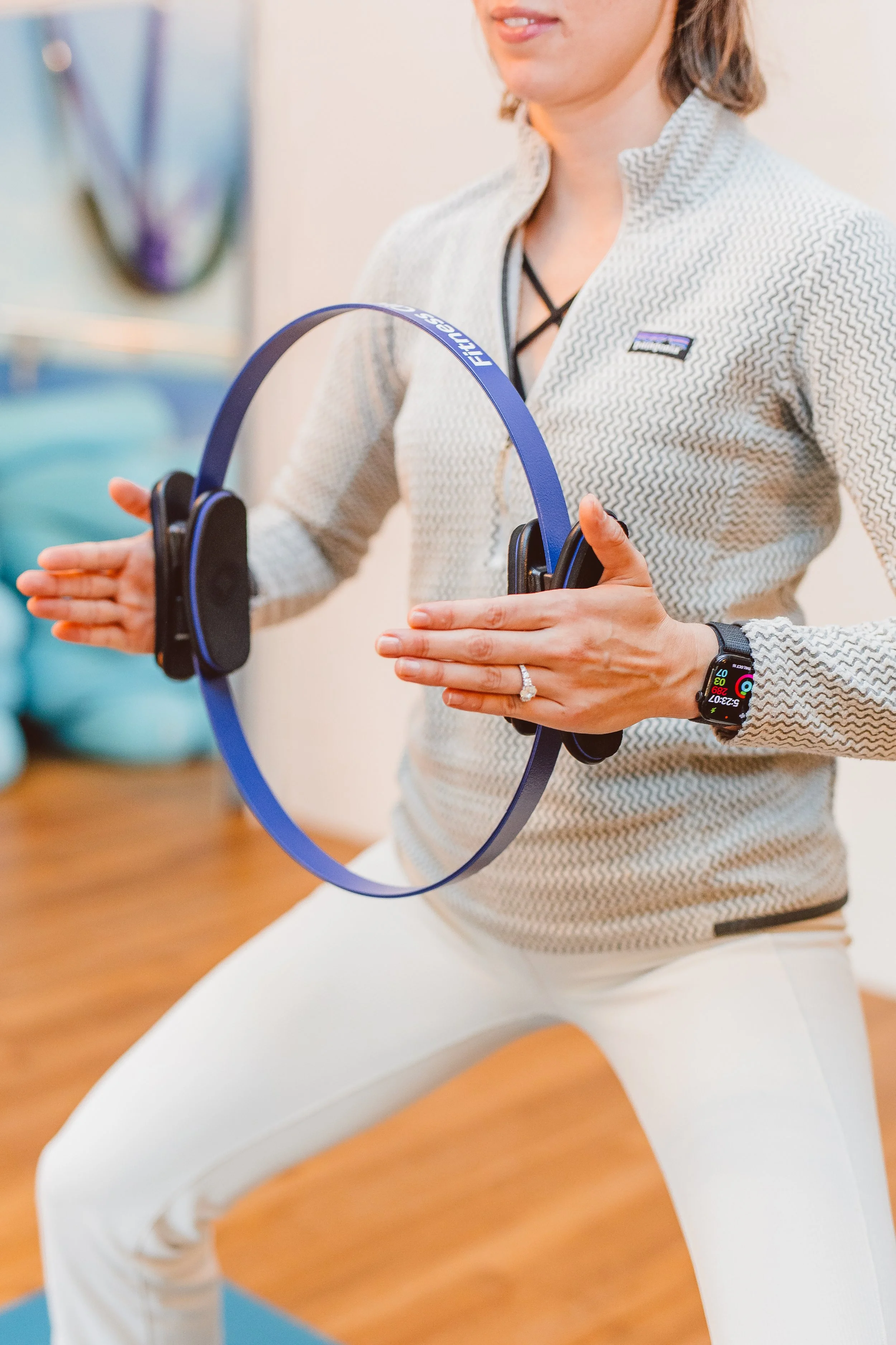 Client warming up for a Pilates or somatic yoga class at Coastal Retreat Studios in Easton, MD — active wear and mindful movement