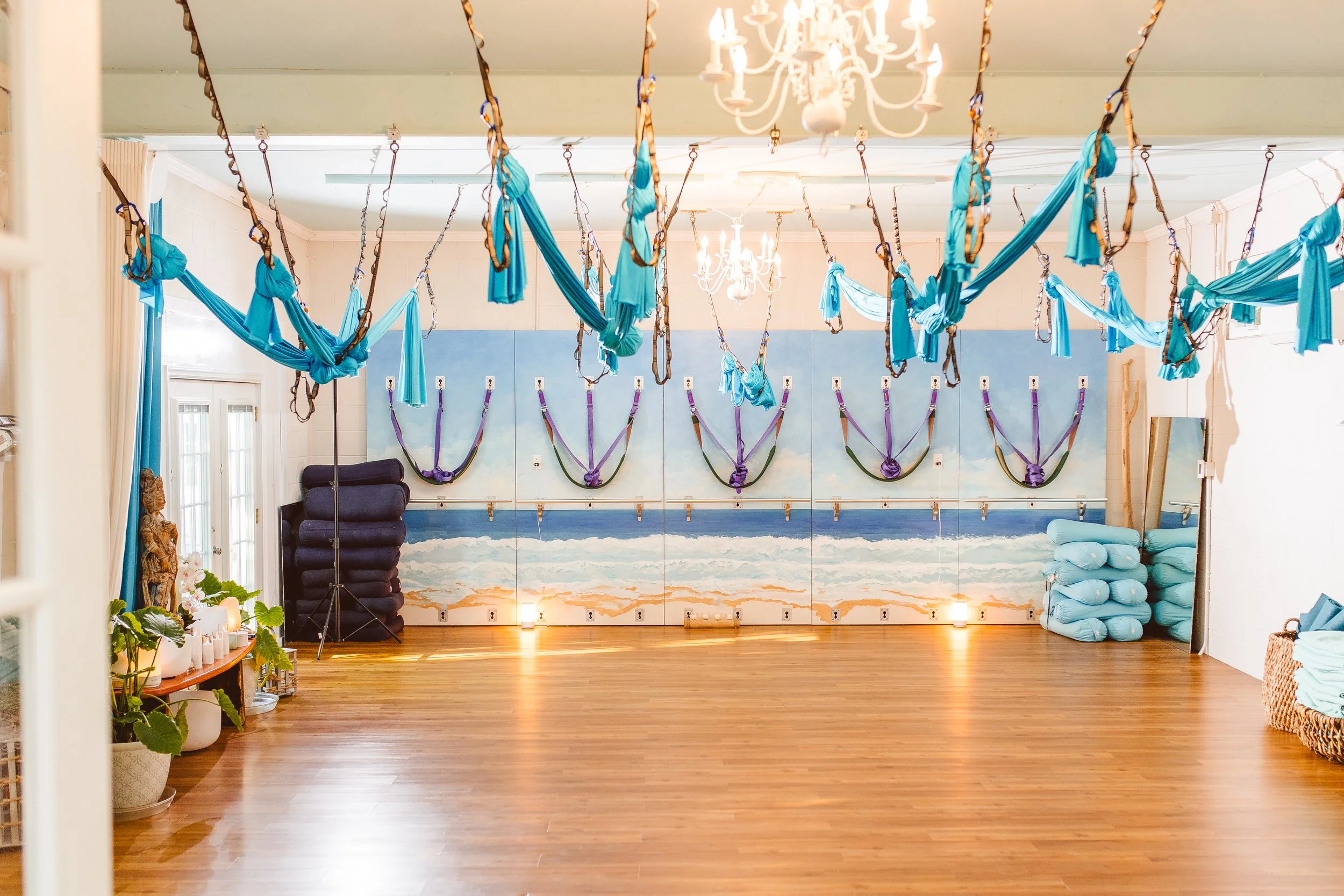 Aerial yoga studio space at Coastal Retreat Studios in Easton, MD — hammock straps ready for a Restore 30 or aerial somatic yoga session