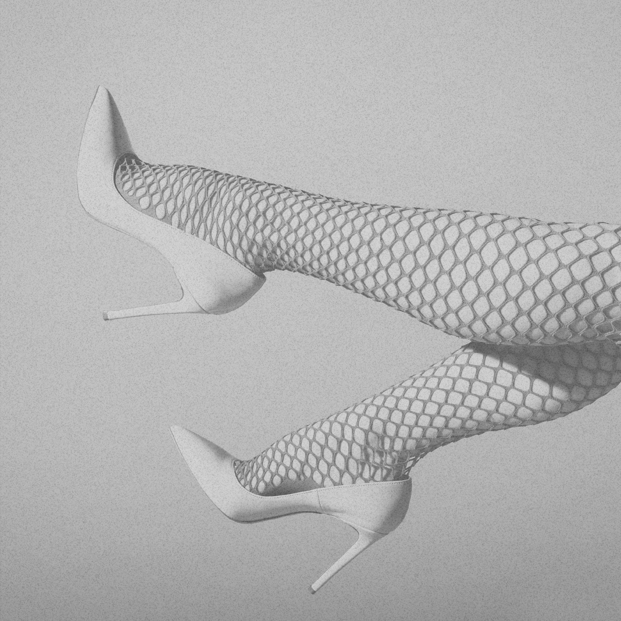 A pair of legs in fishnet stockings with high heels, reflected on a glossy surface.