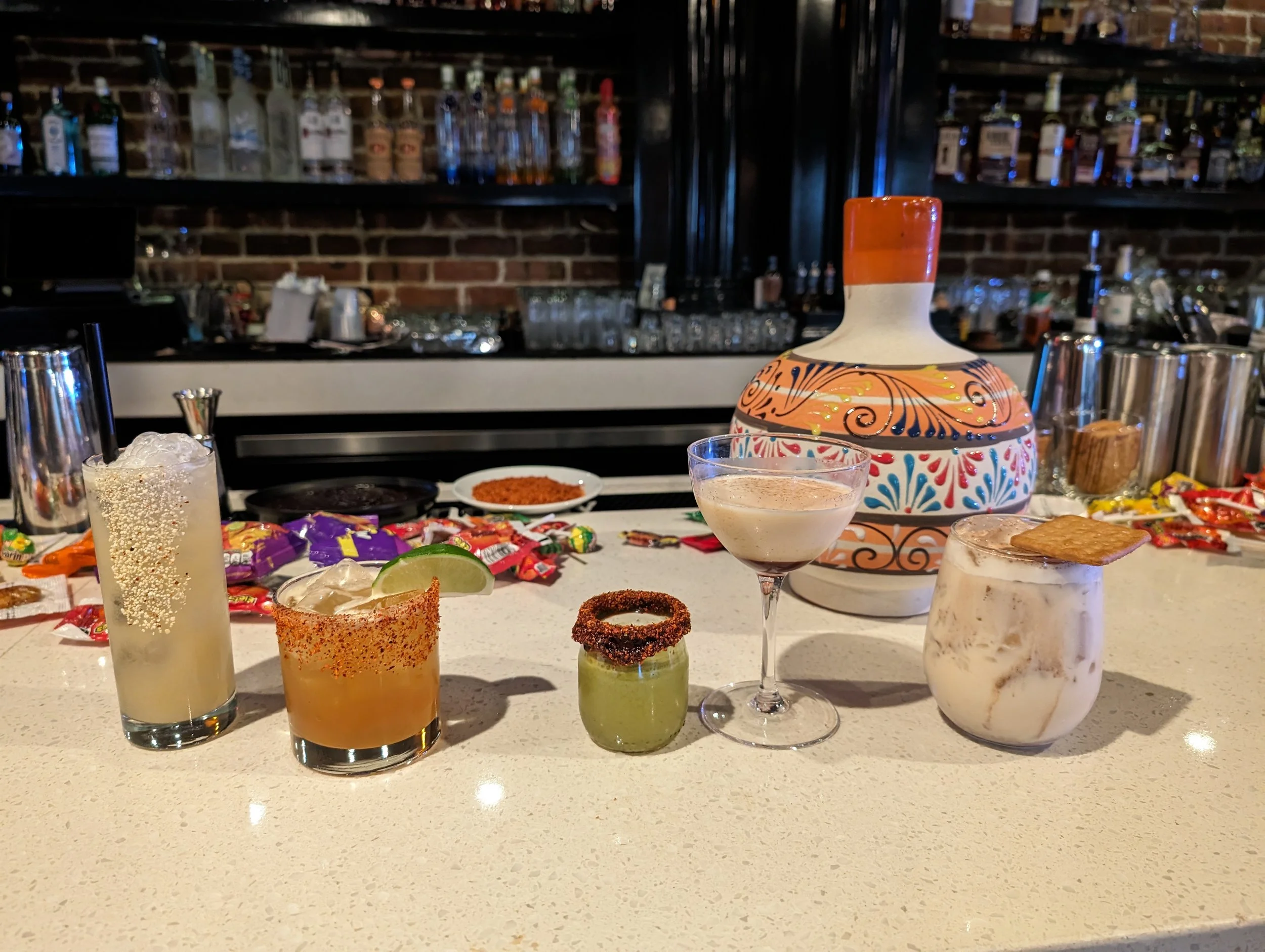 Pura Buddah presents various cocktails with unique colors and textures. Multiple styles of glassware and garnishes