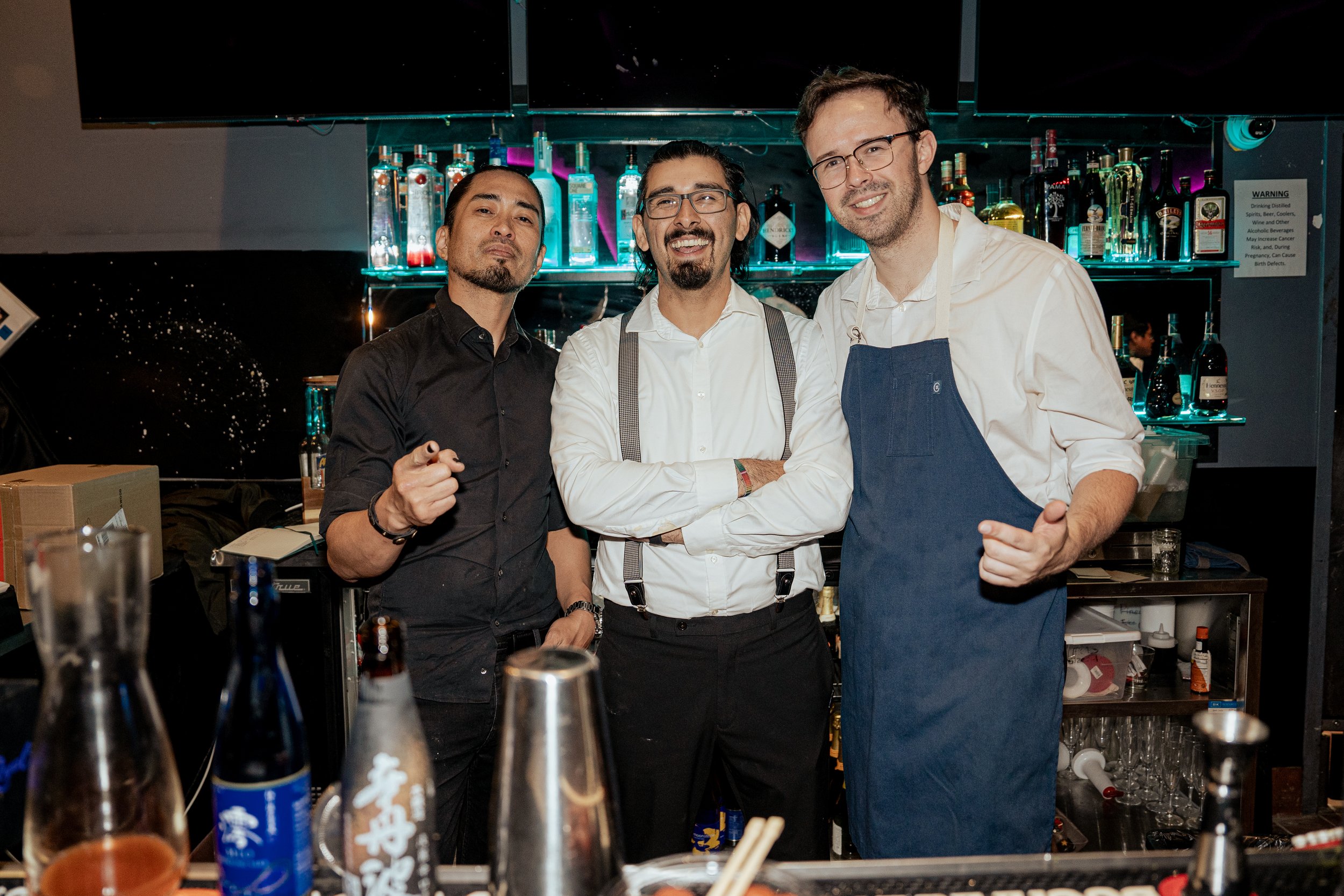 Pura Buddah private event bartenders in front of spirit bottles at a pop up event hosted at a bar in San Jose, California