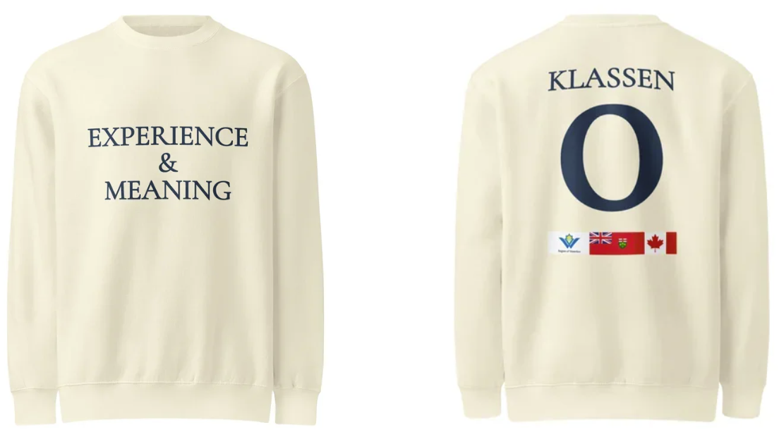 Cream-colored sweatshirt with text reading "Experience & Meaning" on the front and "Klassen" with a large letter "O" on the back. The back also features small flags of Waterloo Region, Ontario, Canada.