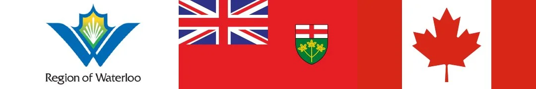 A row of flags representing the Region of Waterloo, the United Kingdom, Ontario, and Canada.