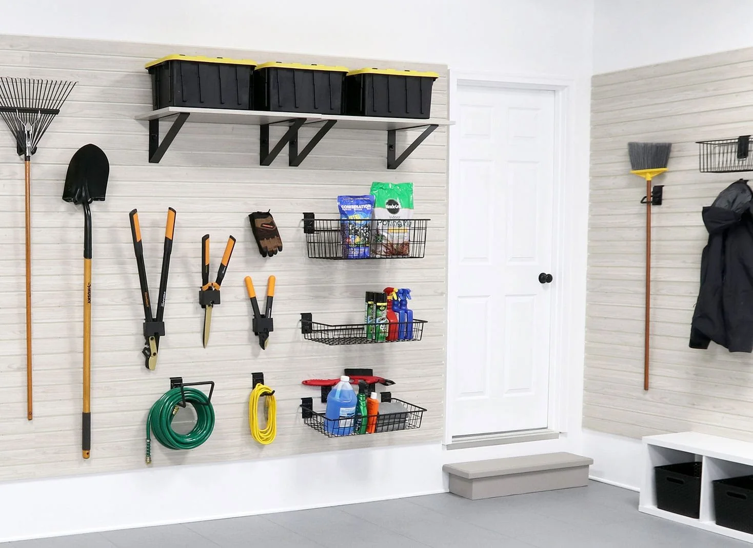 Garage storage with gardening tools, spray bottles, hoses, and organization bins.