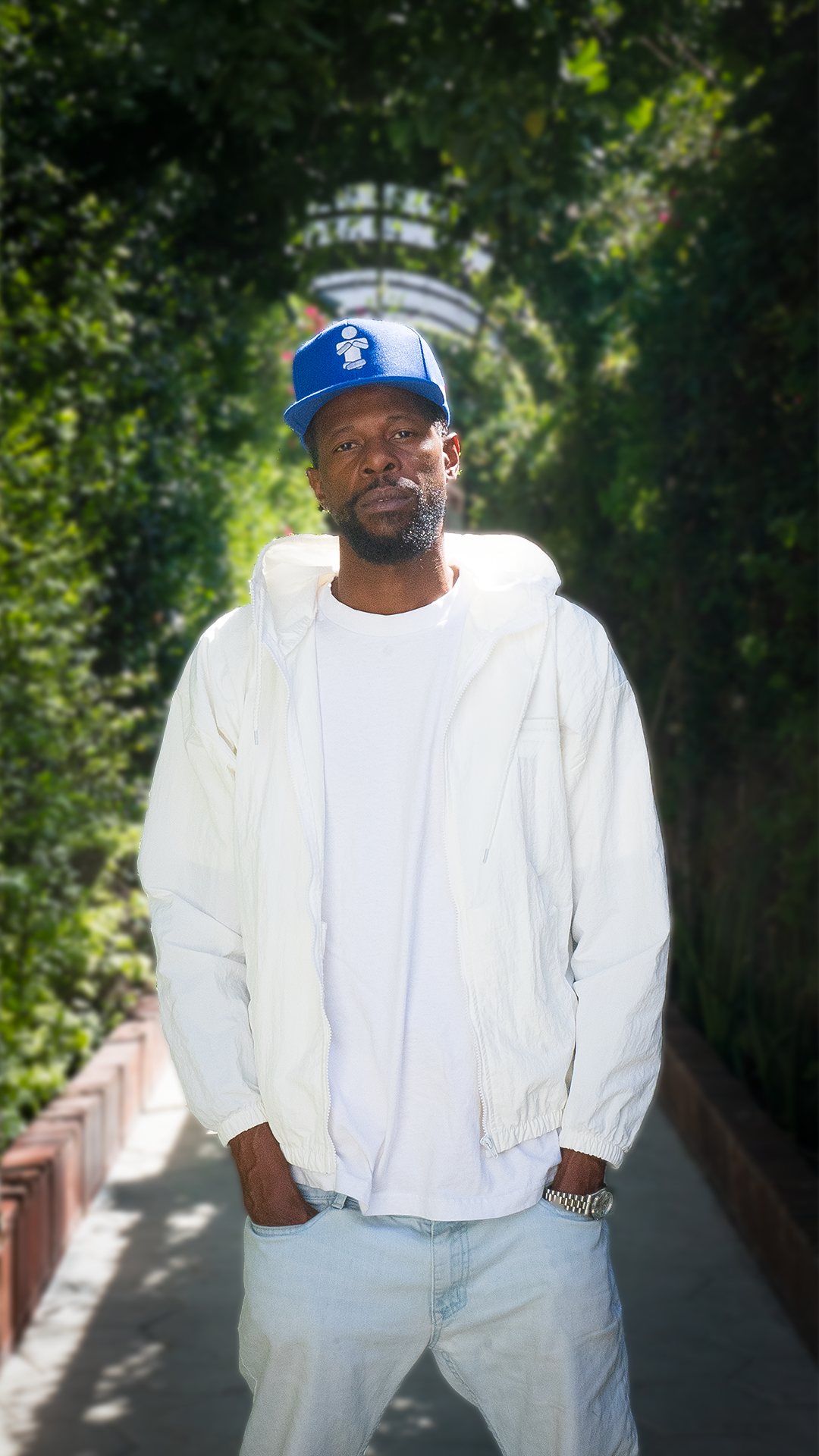 JmisJustMe West coast progressive hip-hop artist in 90's fashion posing in Downtown Los Angeles