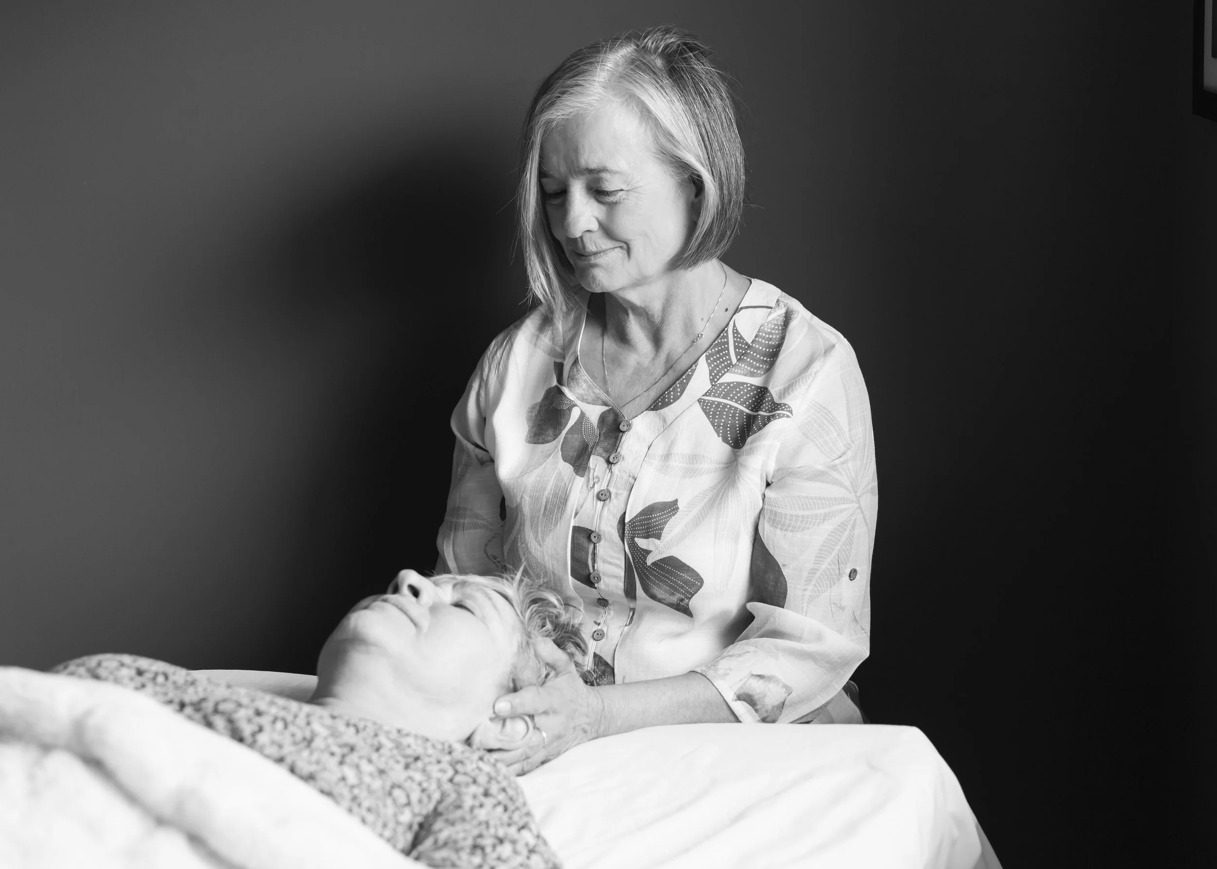 A grayscale photograph of gentle healing and working towards growth and comfort.