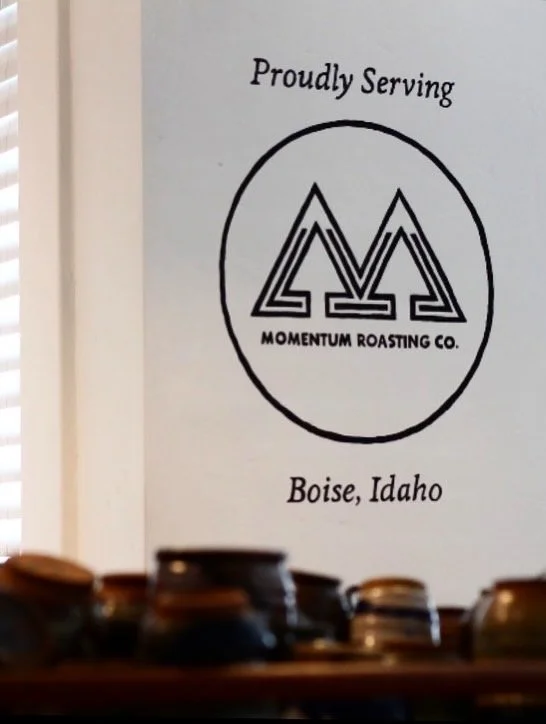 A wall with a logo for Momentum Roasting Co. and the text "Proudly Serving Boise, Idaho."