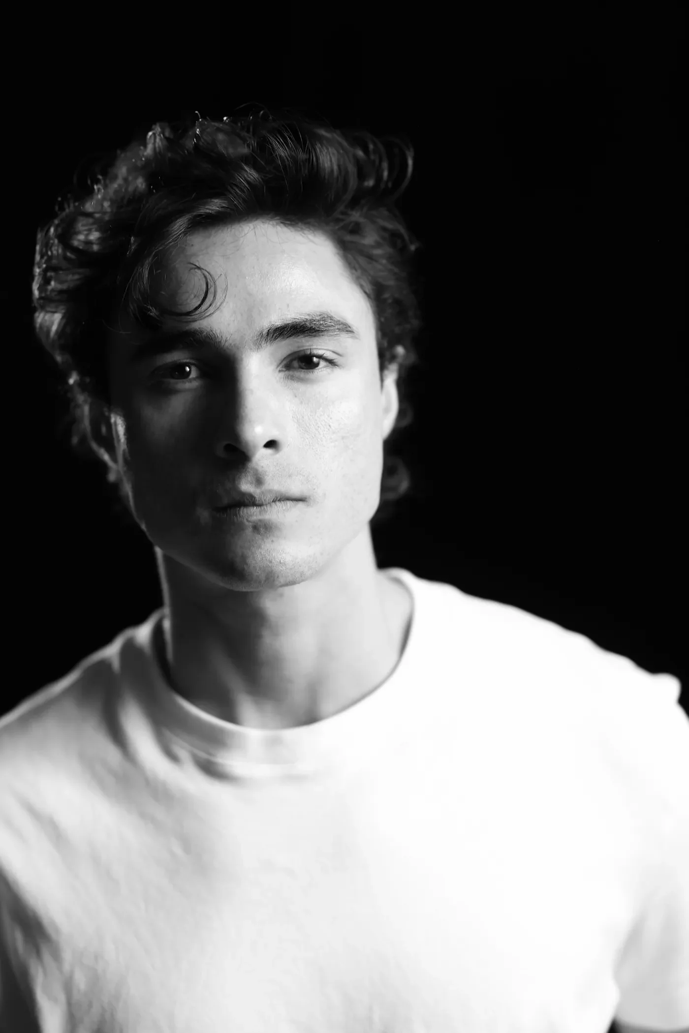 Luis del Toro actor black and white portrait with dramatic lighting and serious expression