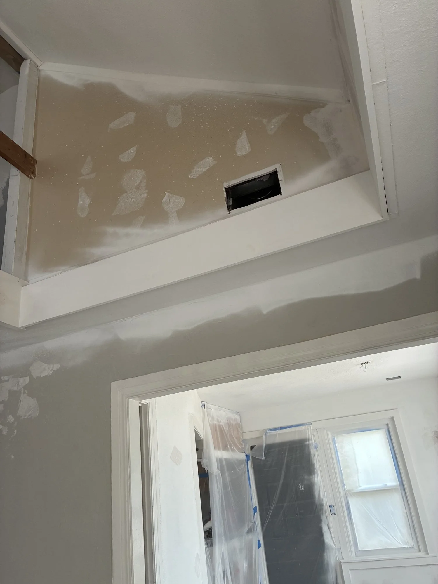 Patched wall surfaces and joints around an elevated opening during drywall preparation