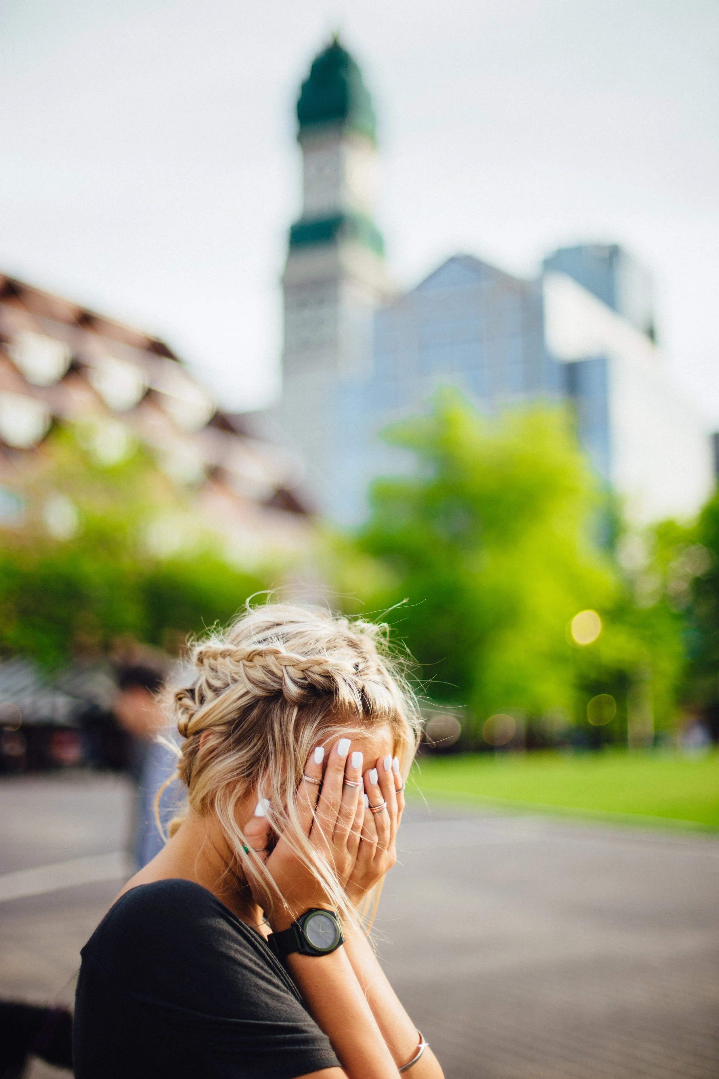 Woman with hands over face experiencing emotion of defeat