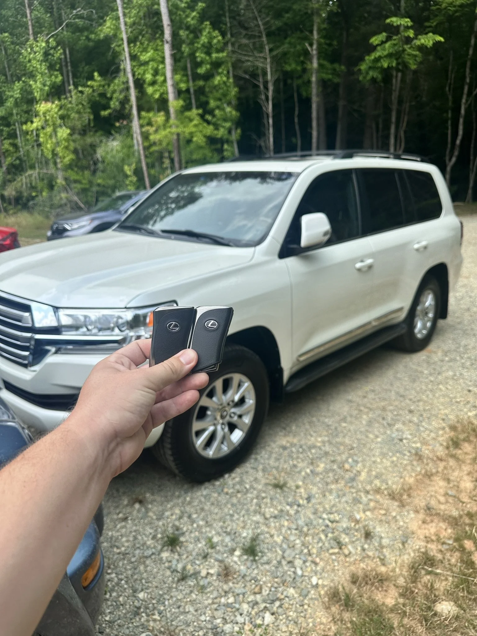 Automotive locksmith in Raleigh NC holding a newly programmed Ford Bronco key fob after mobile car key replacement service.