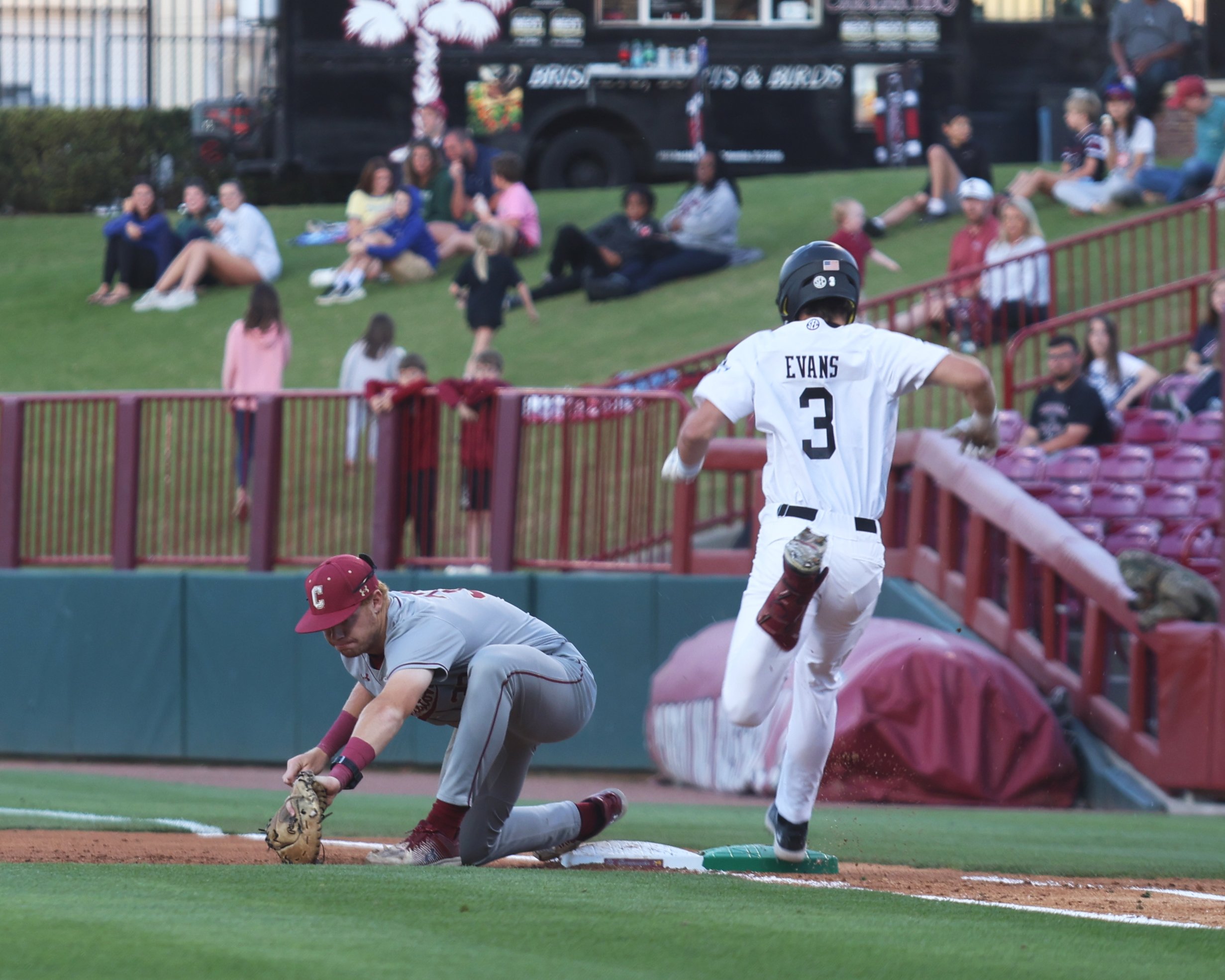 Junior infielder Patrick Evans hustles to first base as College of Charleston attempts the play in the infield.