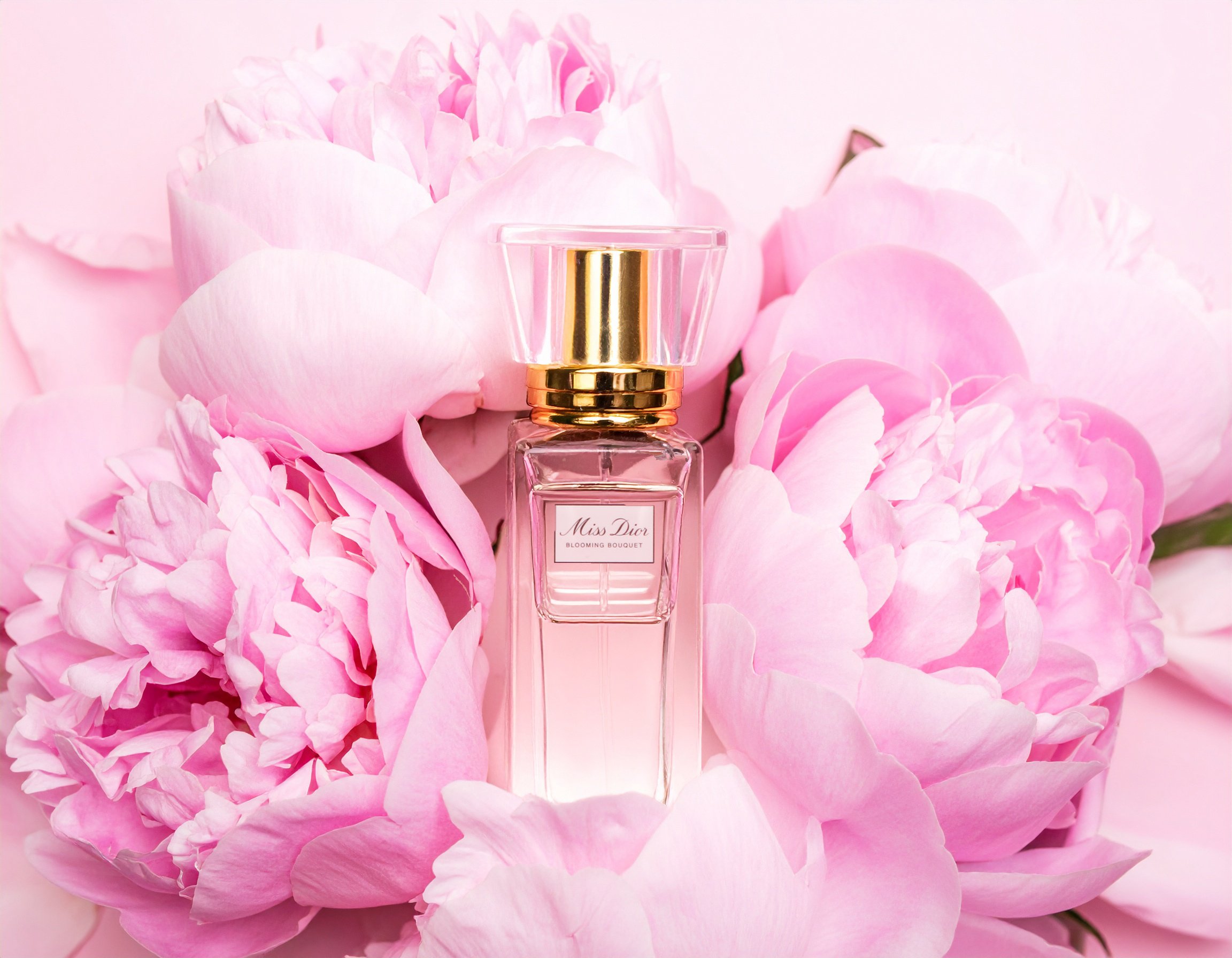 AI Composite Process — AFTER:
Final conceptual fragrance advertisement created by generating an AI floral background in Adobe Firefly, then compositing the generated backdrop with the original product photograph in Adobe Photoshop. This final image d